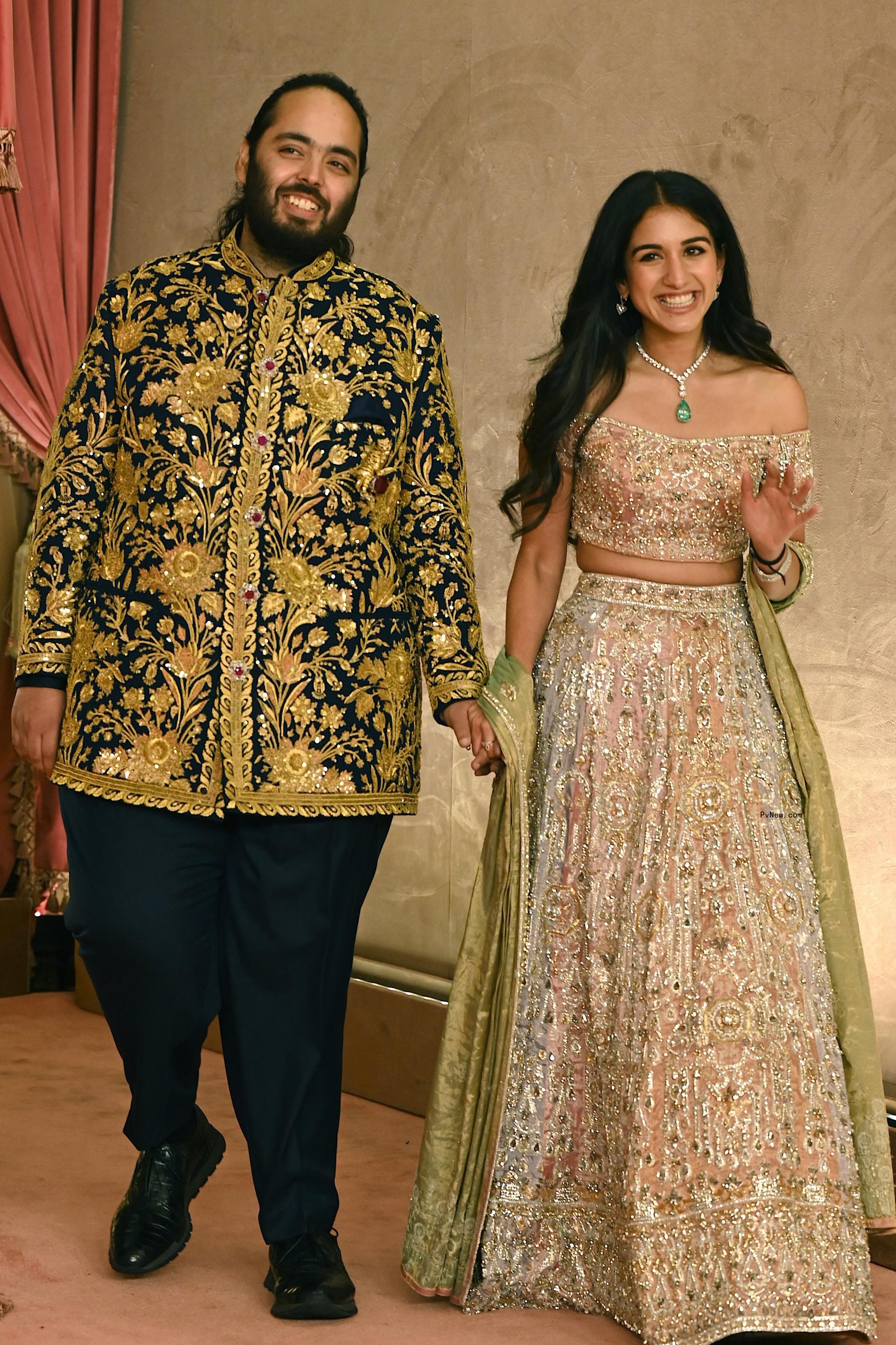 Anant Ambani son of billio<i></i>naire tycoon and Chairman of Reliance Industries Mukesh Ambani (unseen) with his fiancee Radhika Merchant pose for a picture during their Sangeet Ceremony in Mumbai, on July 5, 2024.