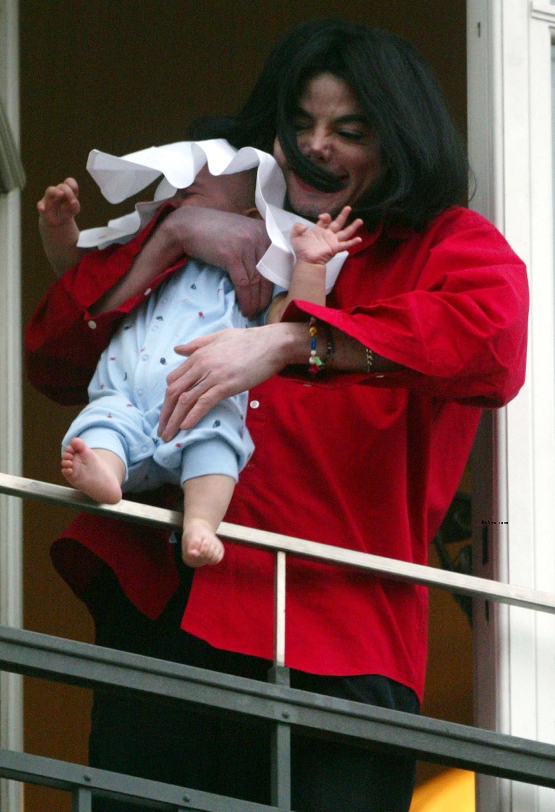 Michael Jackson hanging his son Blanket over a balcony.