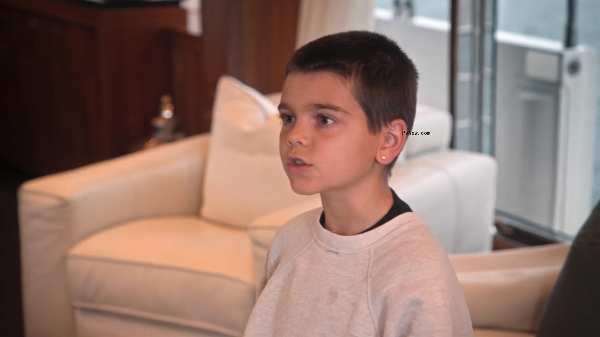 Reign Disick on a yacht with his mom and Travis Barker. 