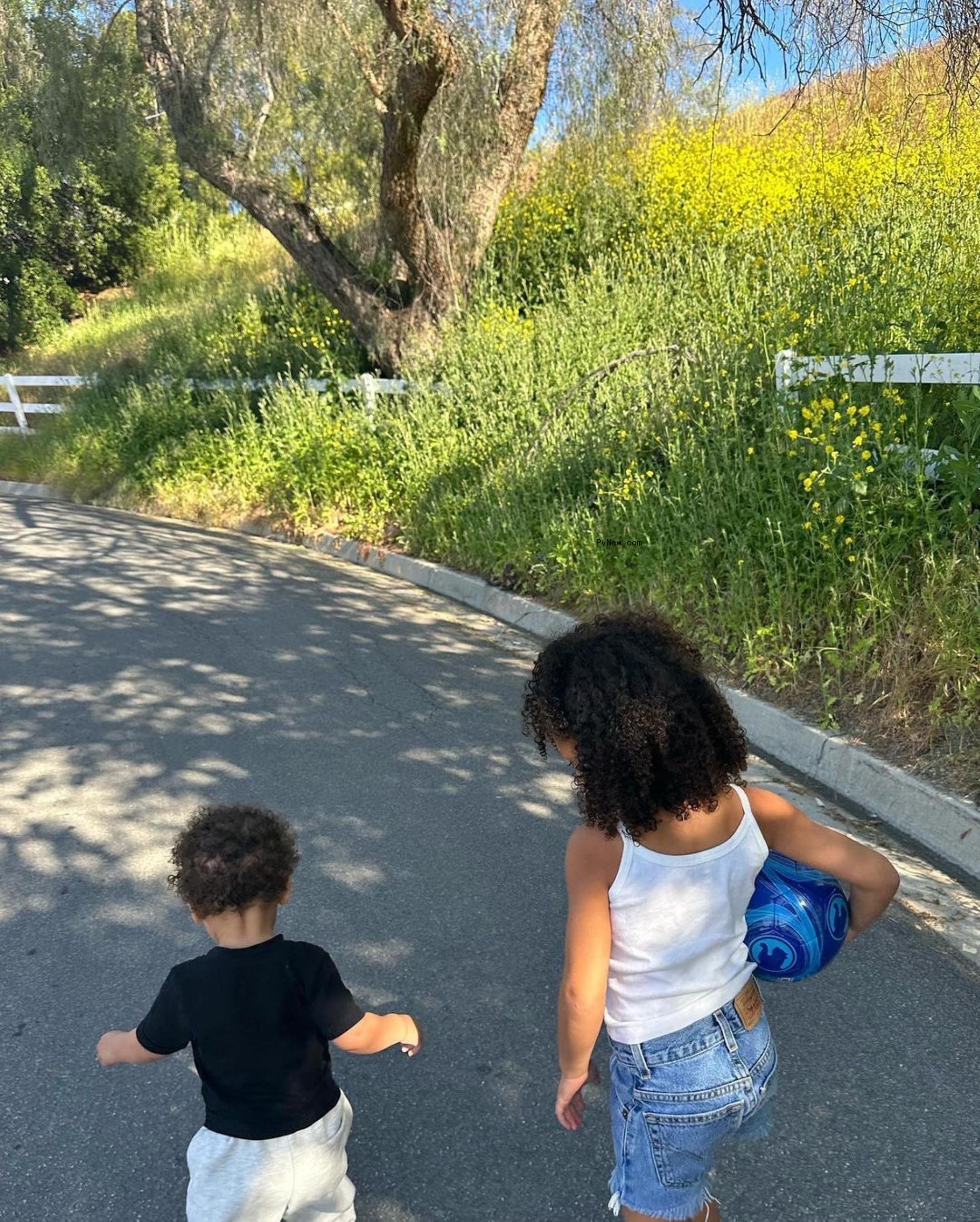 Aire and Stormi Webster walking together