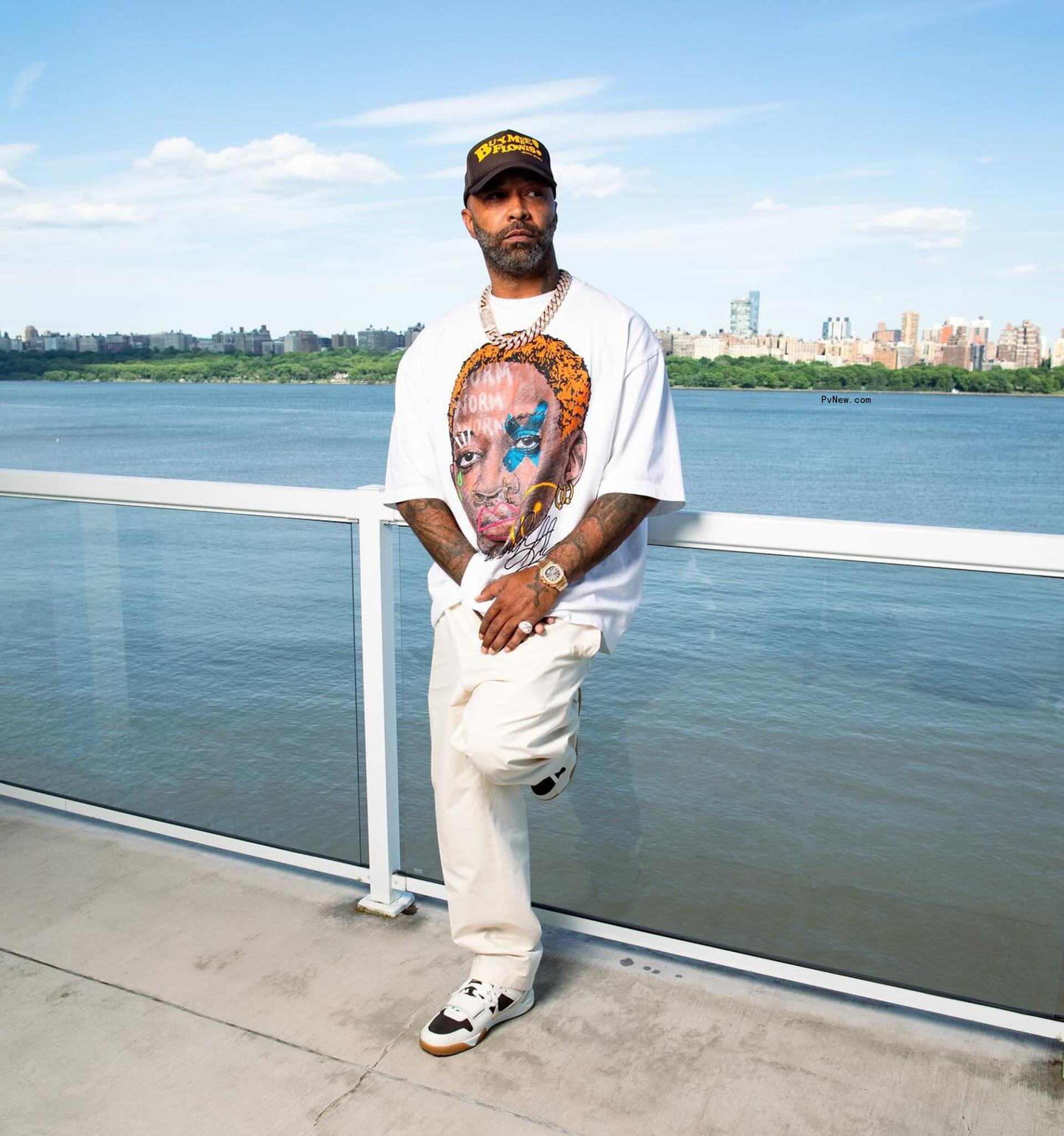Joe Budden posing by the water. 