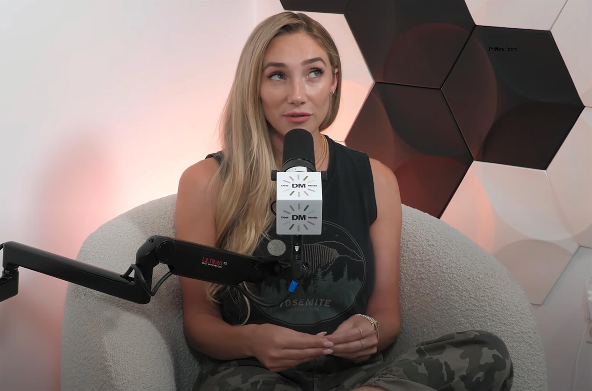 aurora culpo giving side eye talking into a microphone