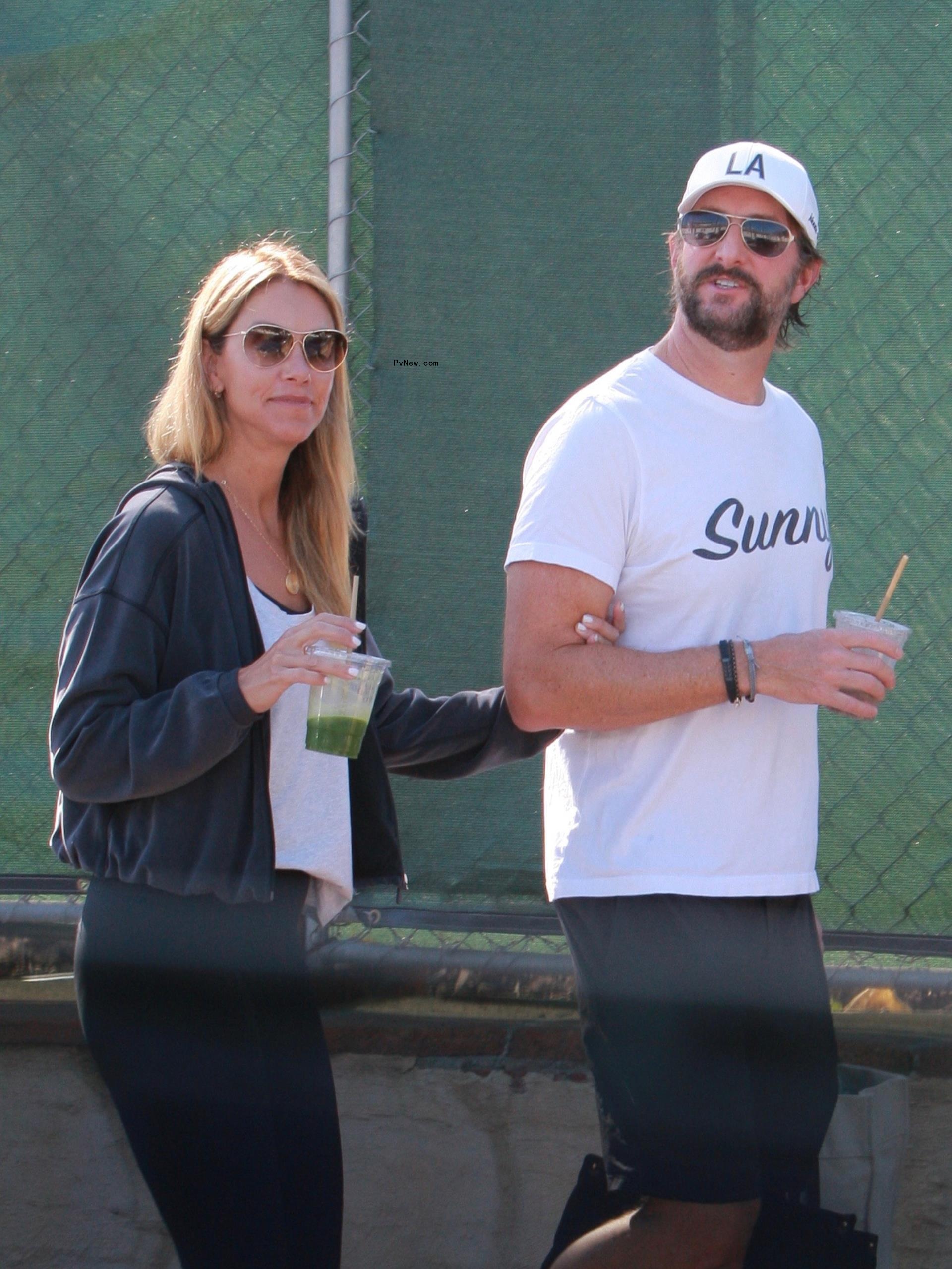 Christine Baumgartner and her boyfriend, Josh Connor, walking with arms l<i></i>inked