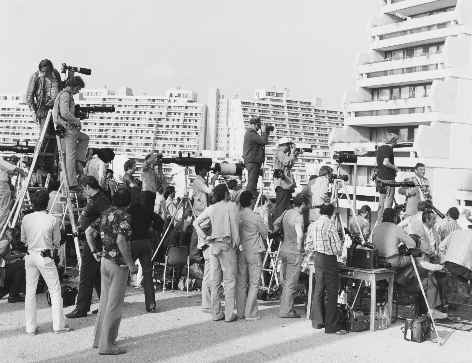 A black-and-white photo of people marching on the street
