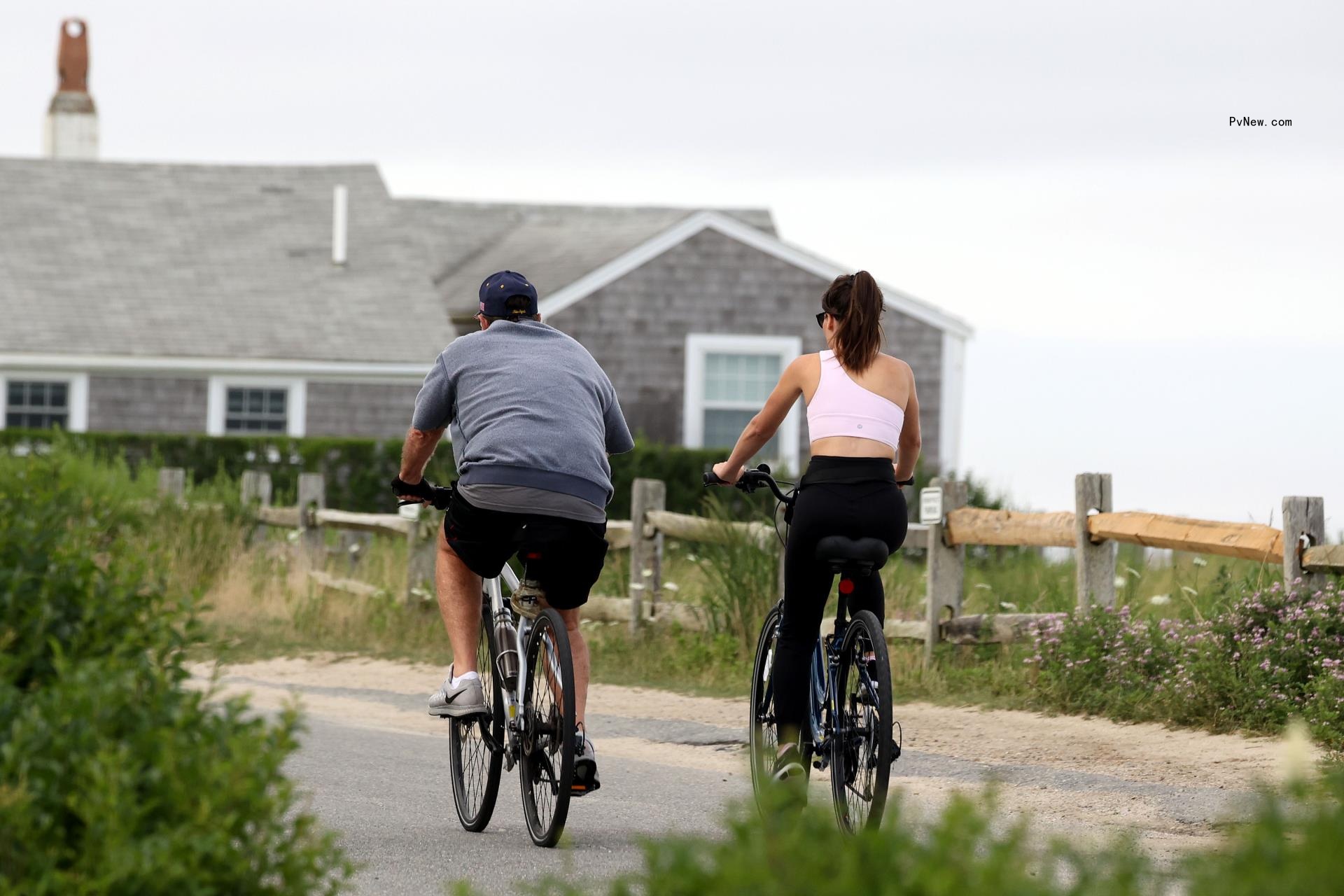 Bill Belichick and Jordon Hudson riding bikes in Nantucket. 