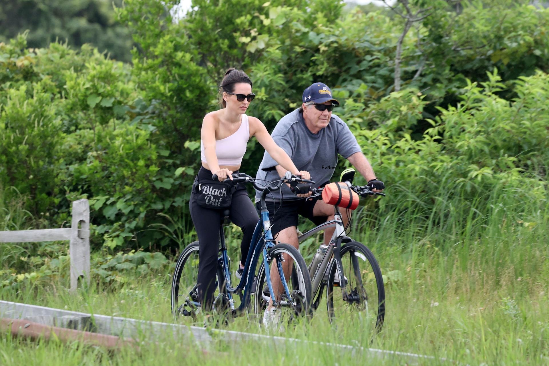 Bill Belichick and Jordon Hudson riding bikes in Nantucket. 