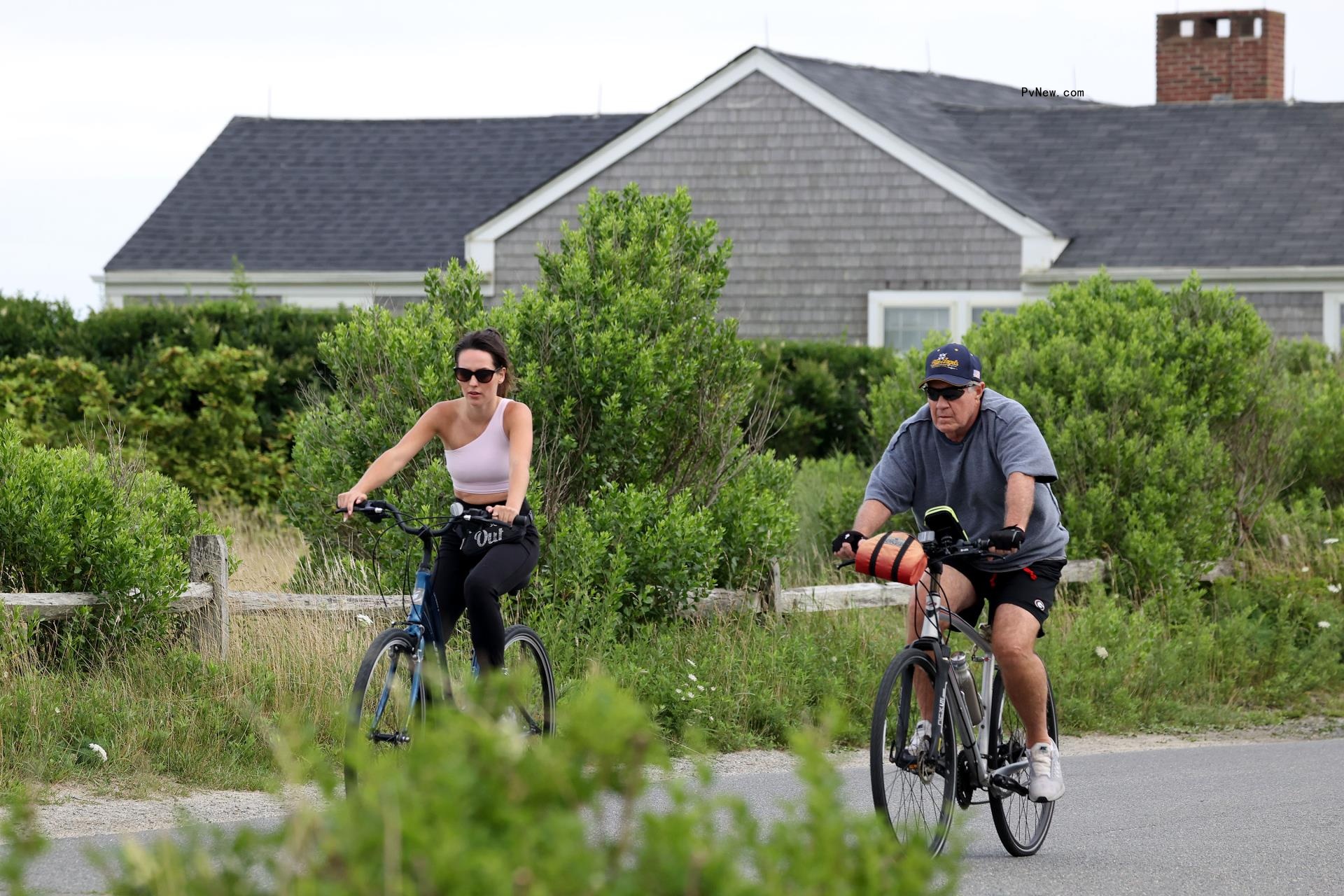Bill Belichick and Jordon Hudson riding bikes in Nantucket. 