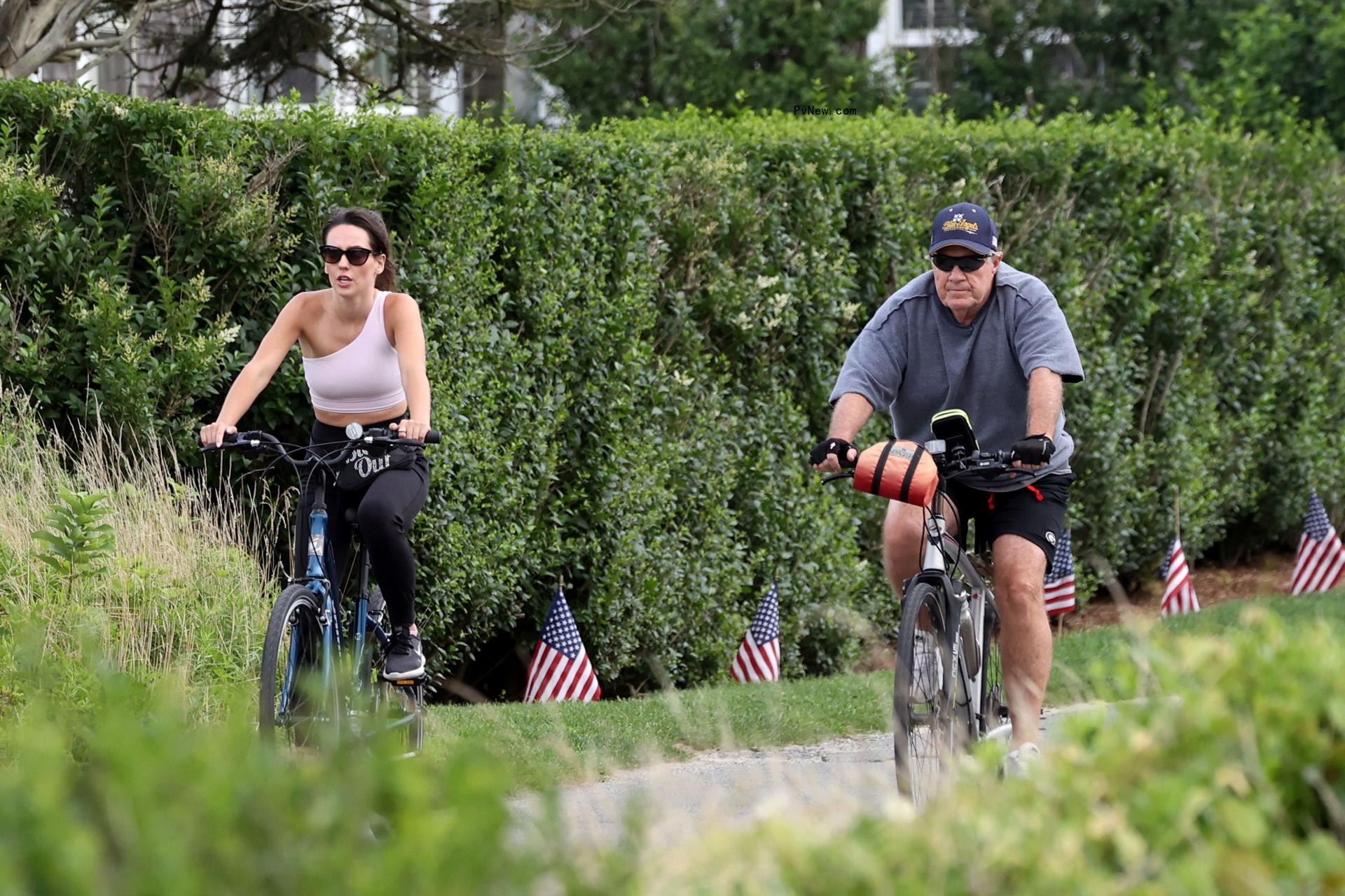 Bill Belichick and Jordon Hudson riding bikes in Nantucket. 
