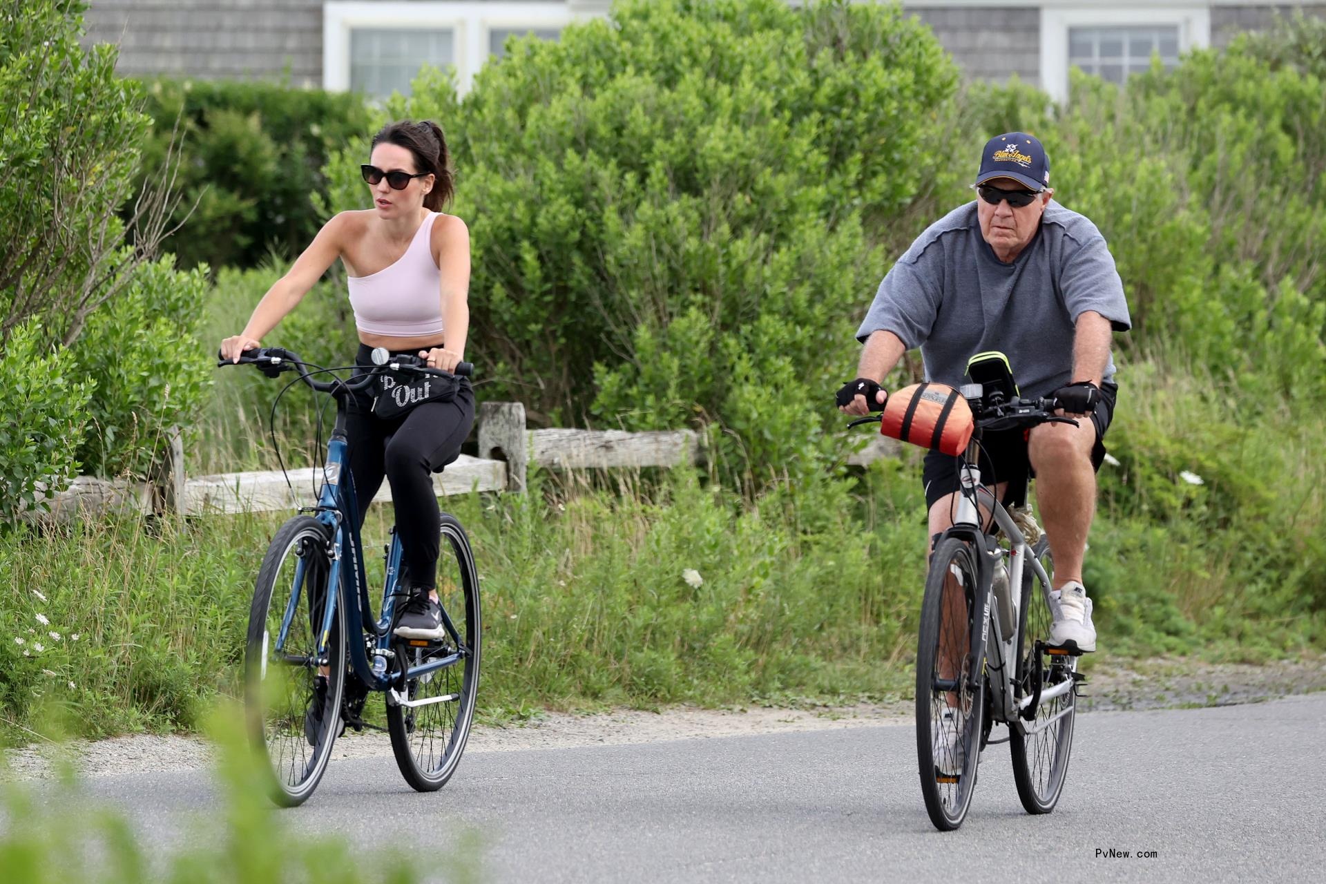Bill Belichick and Jordon Hudson riding bikes in Nantucket. 