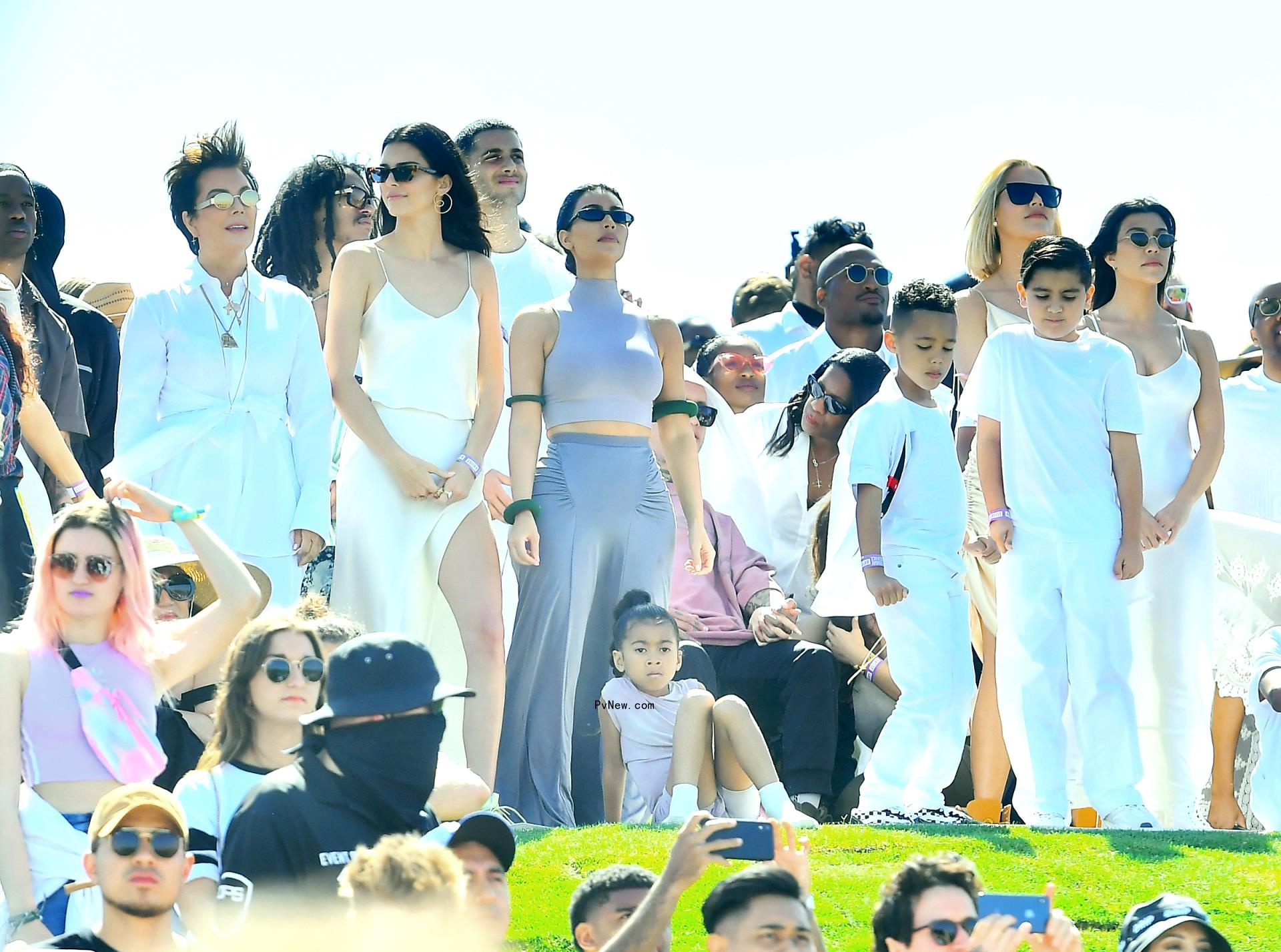 Kanye West singing at Sunday service with Kendall Jenner and Kim Kardashian watching in the audience