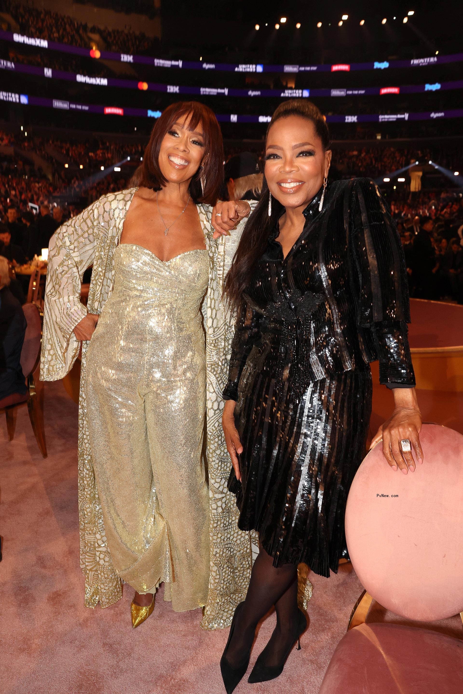 Oprah Winfrey and Gayle King posing in sparkling dresses.