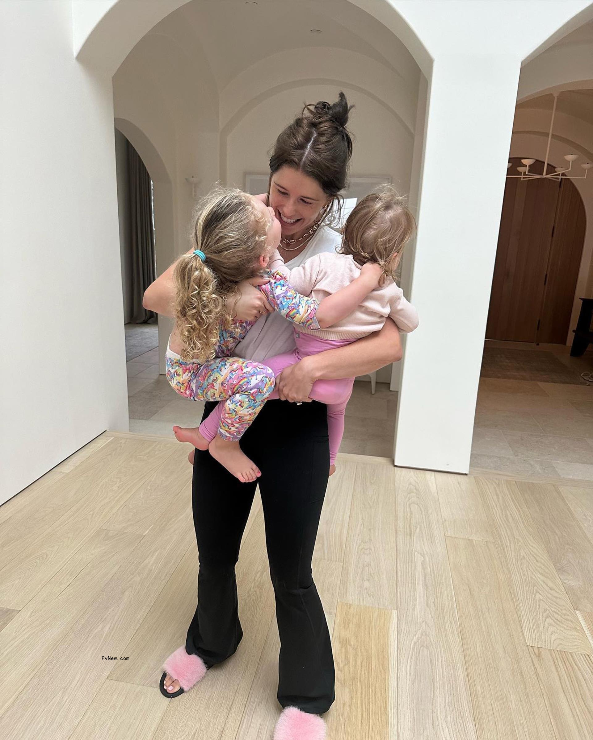 Schwarzenegger carries daughters Lyla and Eloise in an Instagram snap.