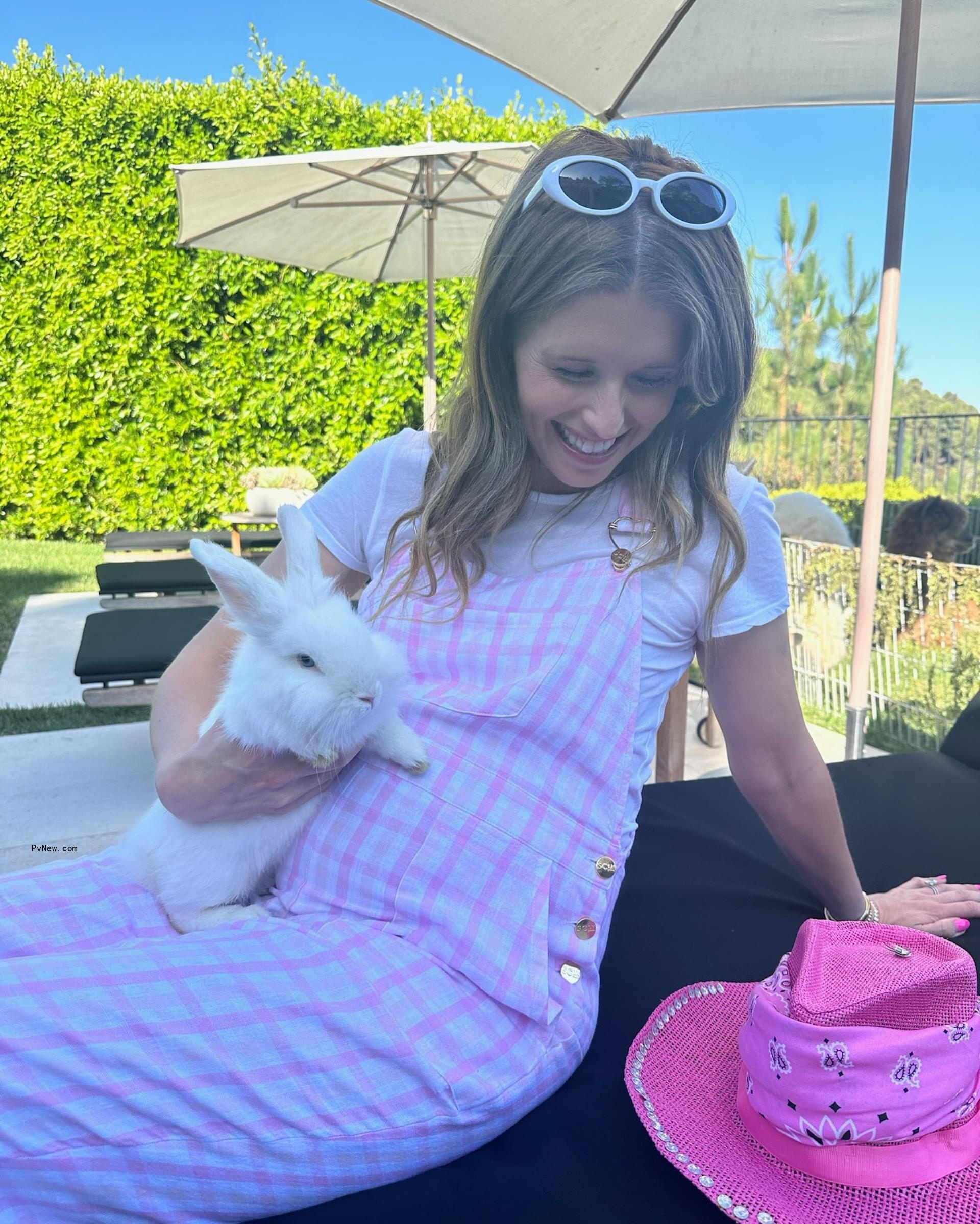 Schwarzenegger showed her budding belly in pink overalls in an Instagram post.