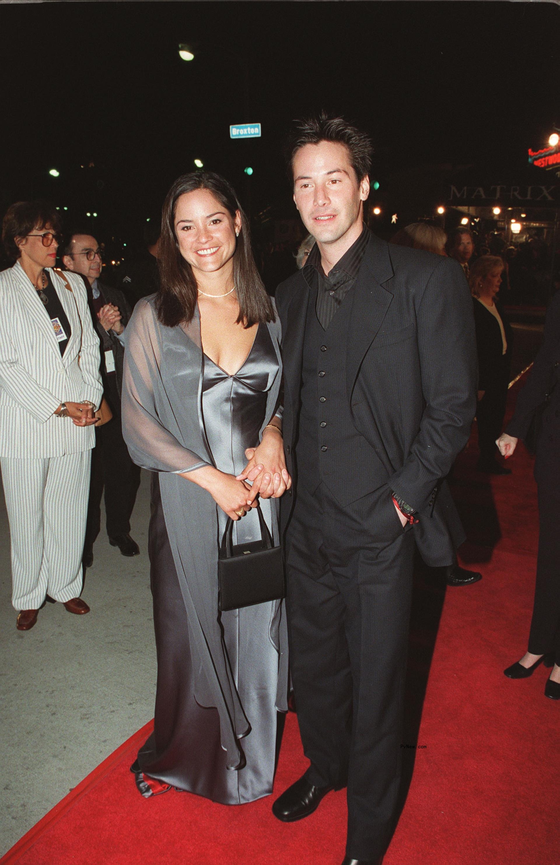 Keanu and Kim Reeves on a red carpet.