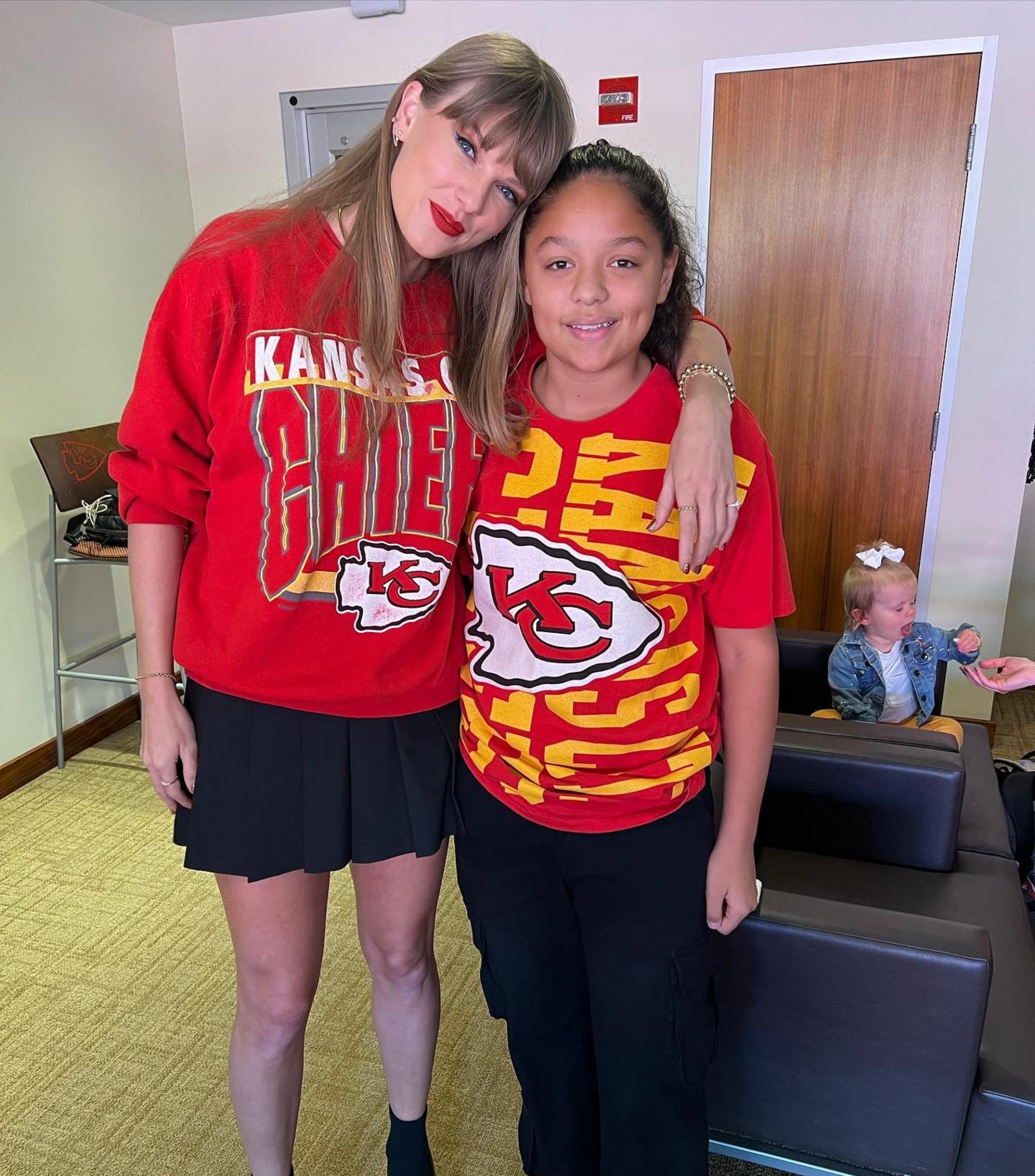 Taylor Swift with a fan in Travis Kelce's suite at Arrowhead Stadium. 