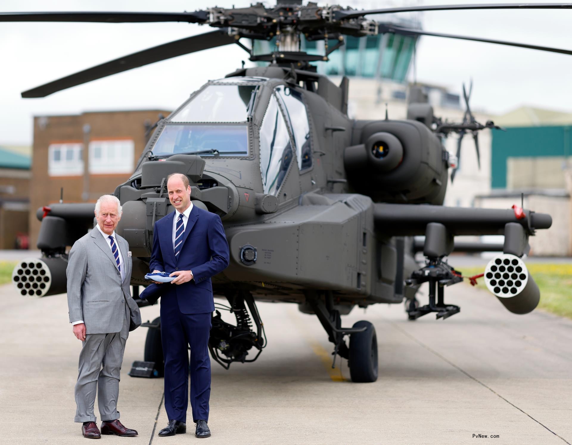 King Charles and Prince William in front of an Apache helicopter.