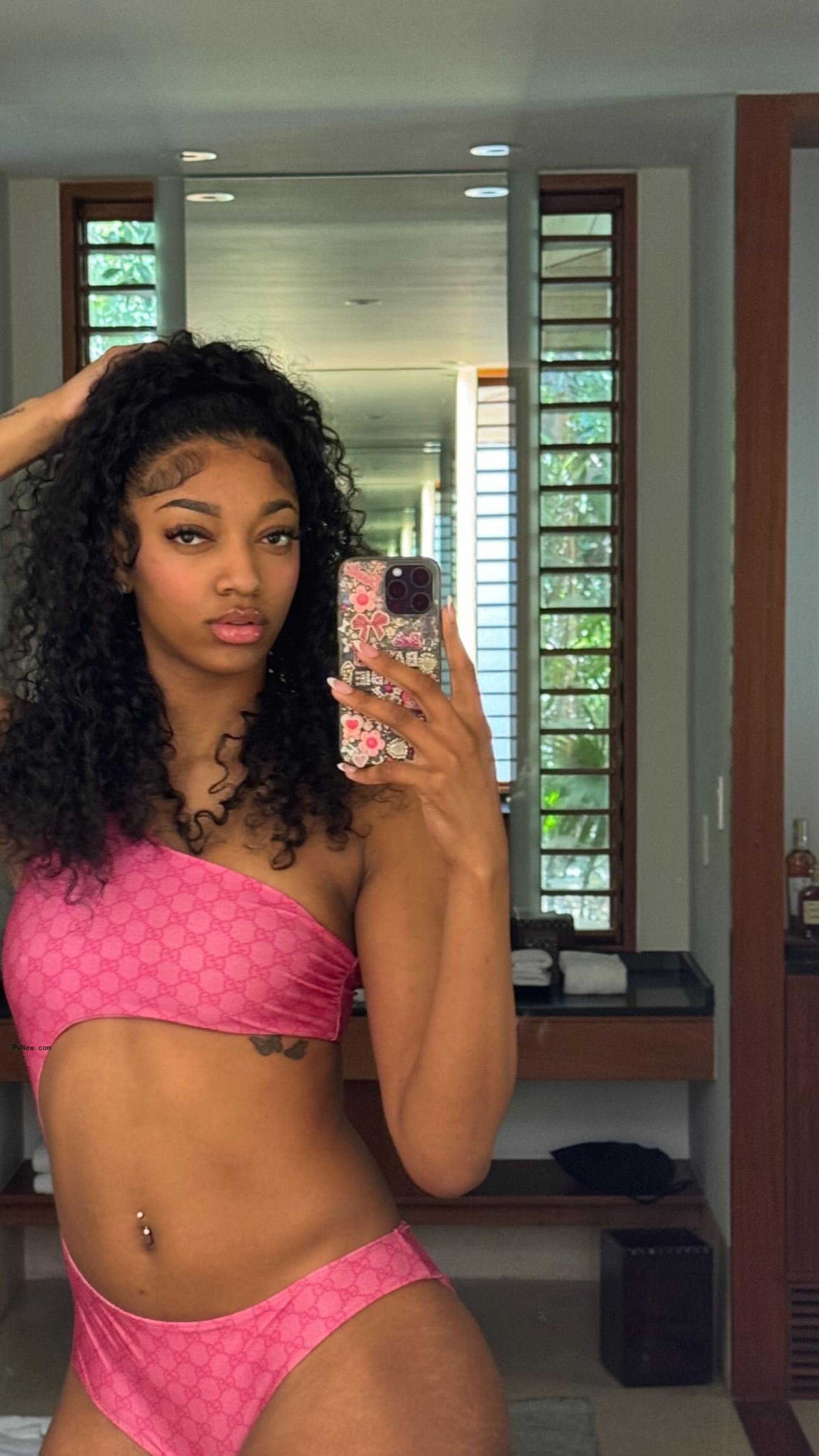A mirror selfie of Angel Reese in a pink Gucci monokini.