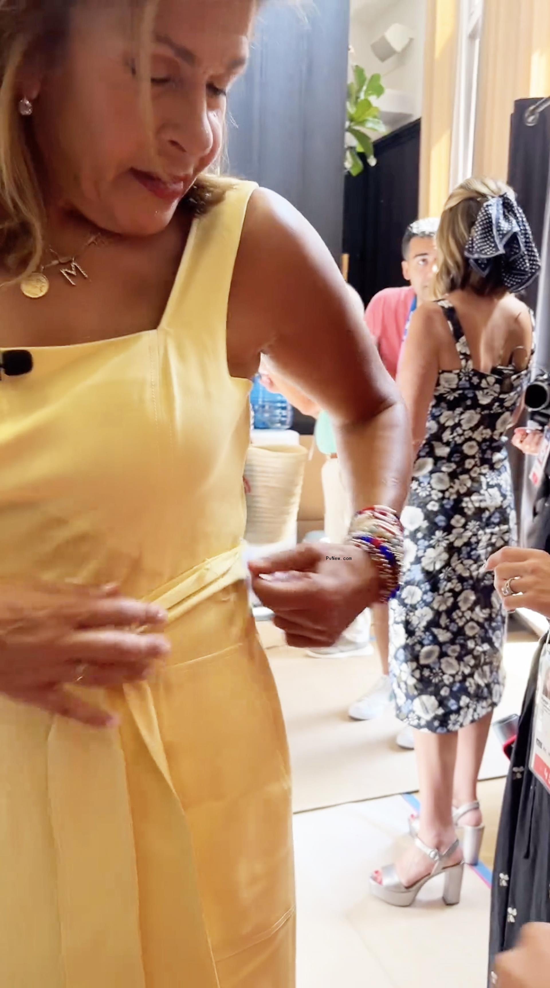 Hoda Kotb getting her yellow dress stapled together