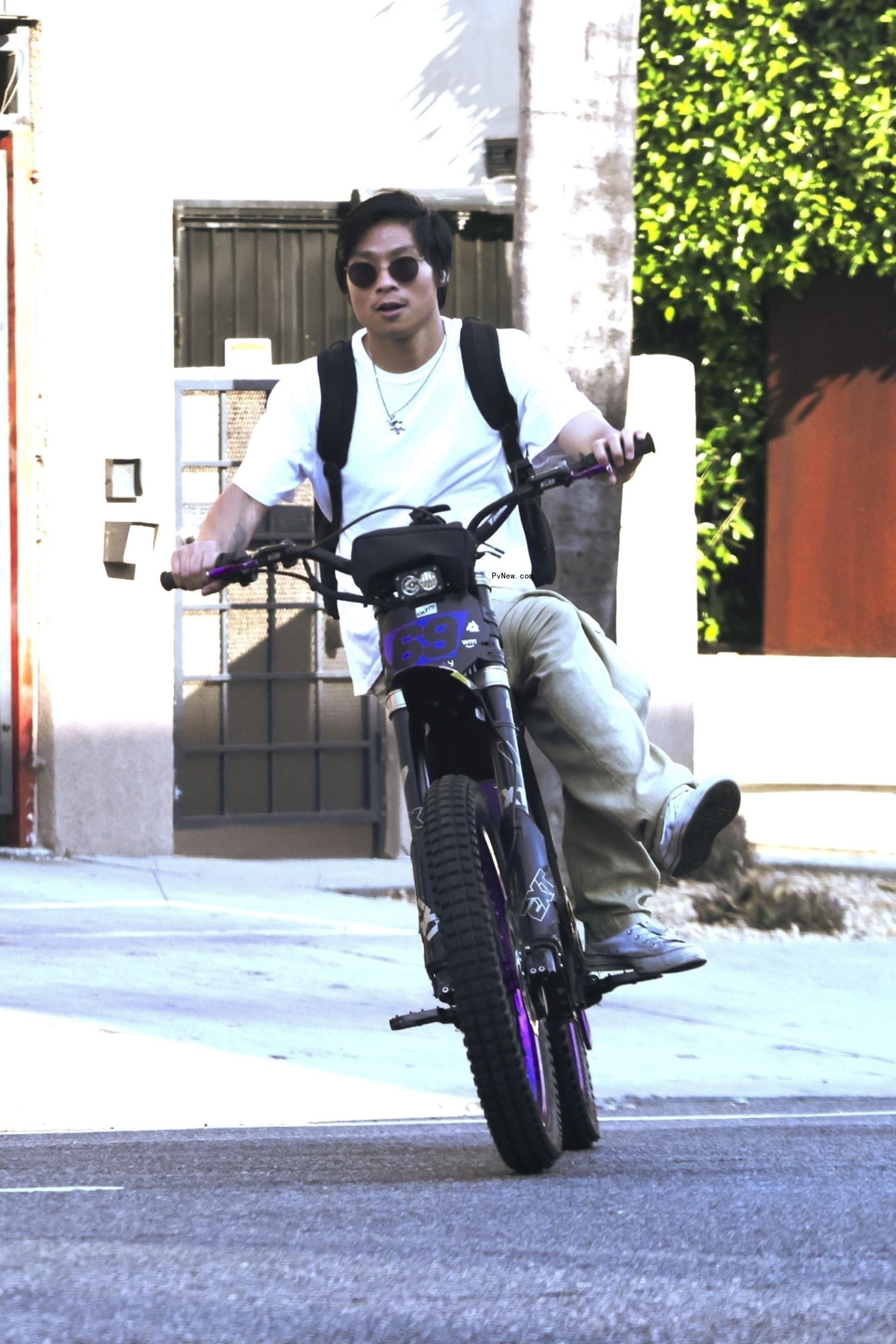 Pax Jolie-Pitt on an e-bike on July 11, 2024.