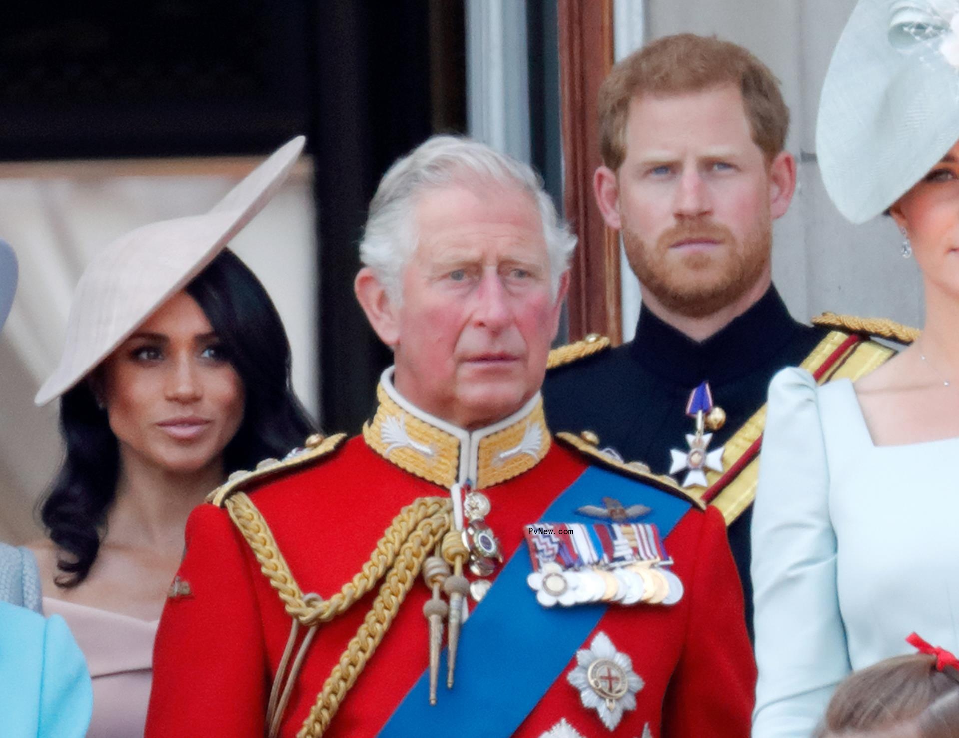Meghan Markle, King Charles III and Prince Harry standing on the balcony of Buckingham Palace in 2018.