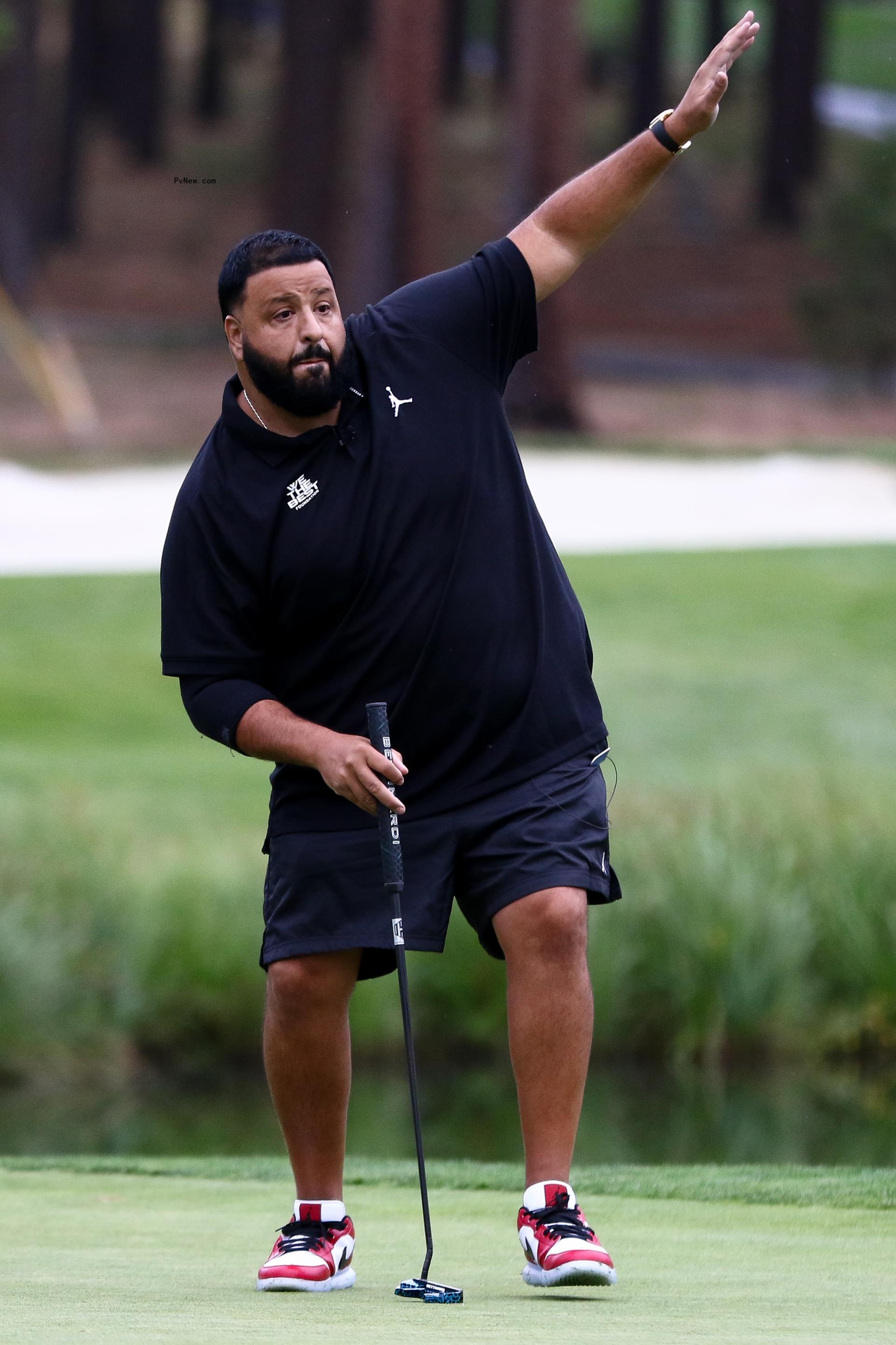 DJ Khaled looking at his ice cream-filled refrigerator.