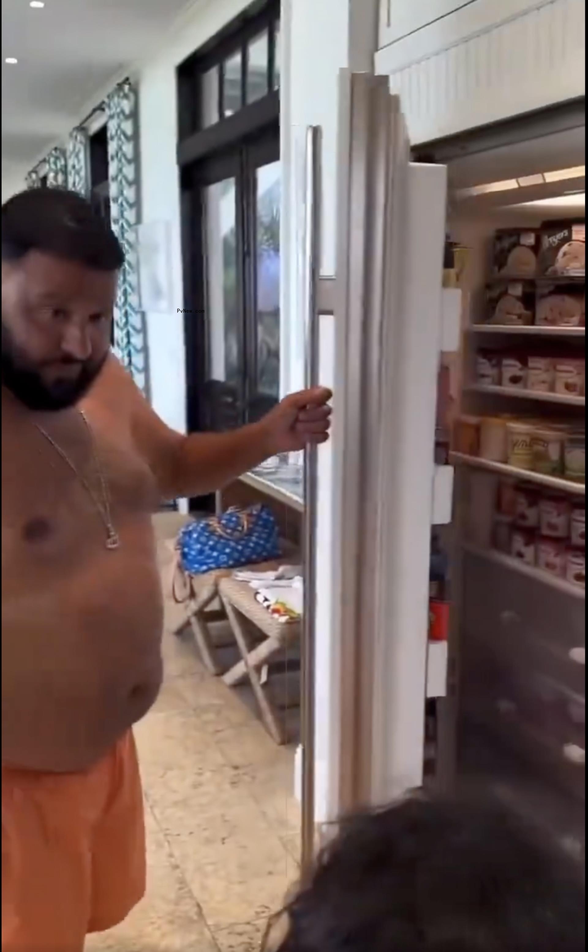 DJ Khaled opening his ice cream-filled refrigerator.