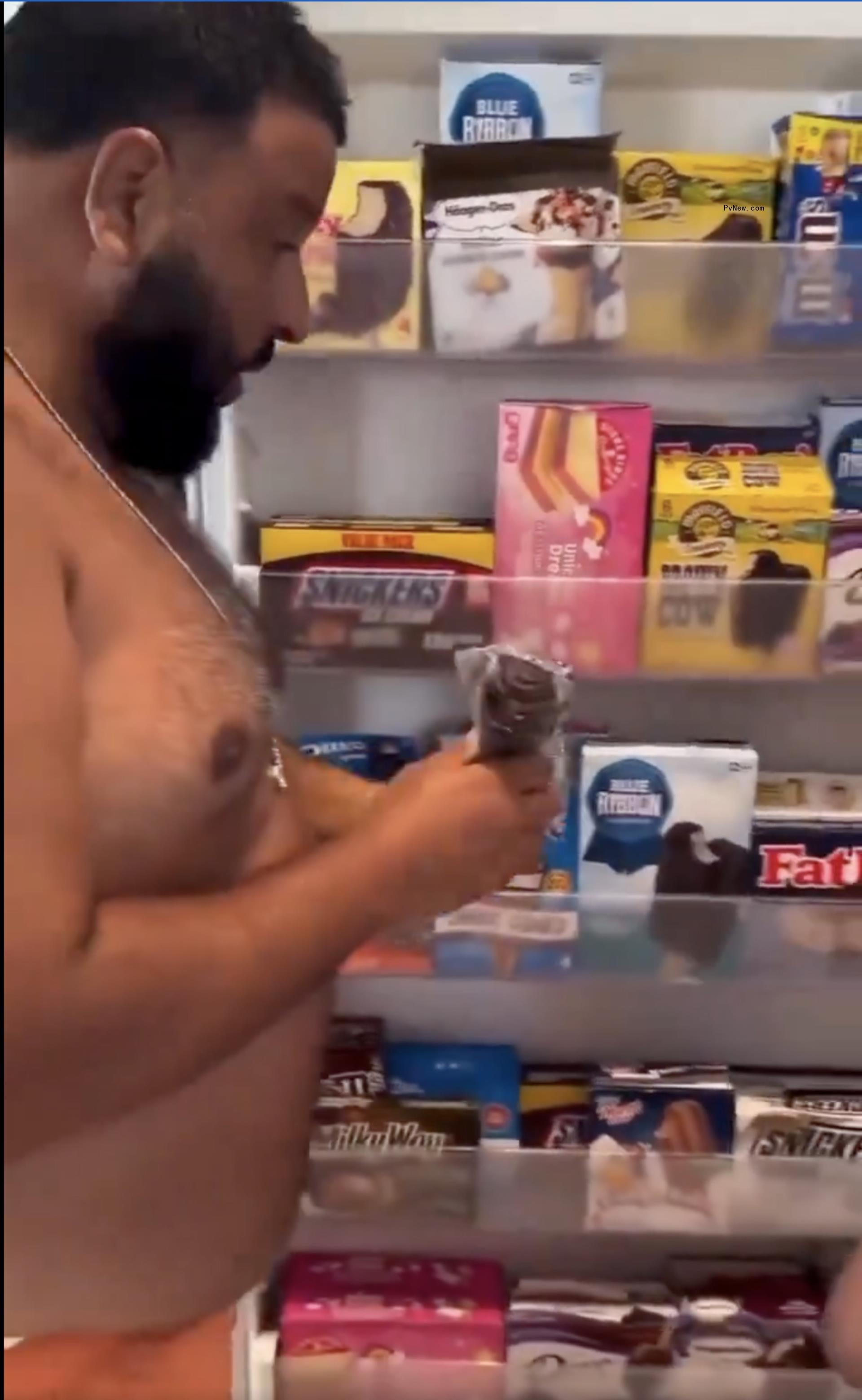 DJ Khaled looking at his ice cream-filled refrigerator.