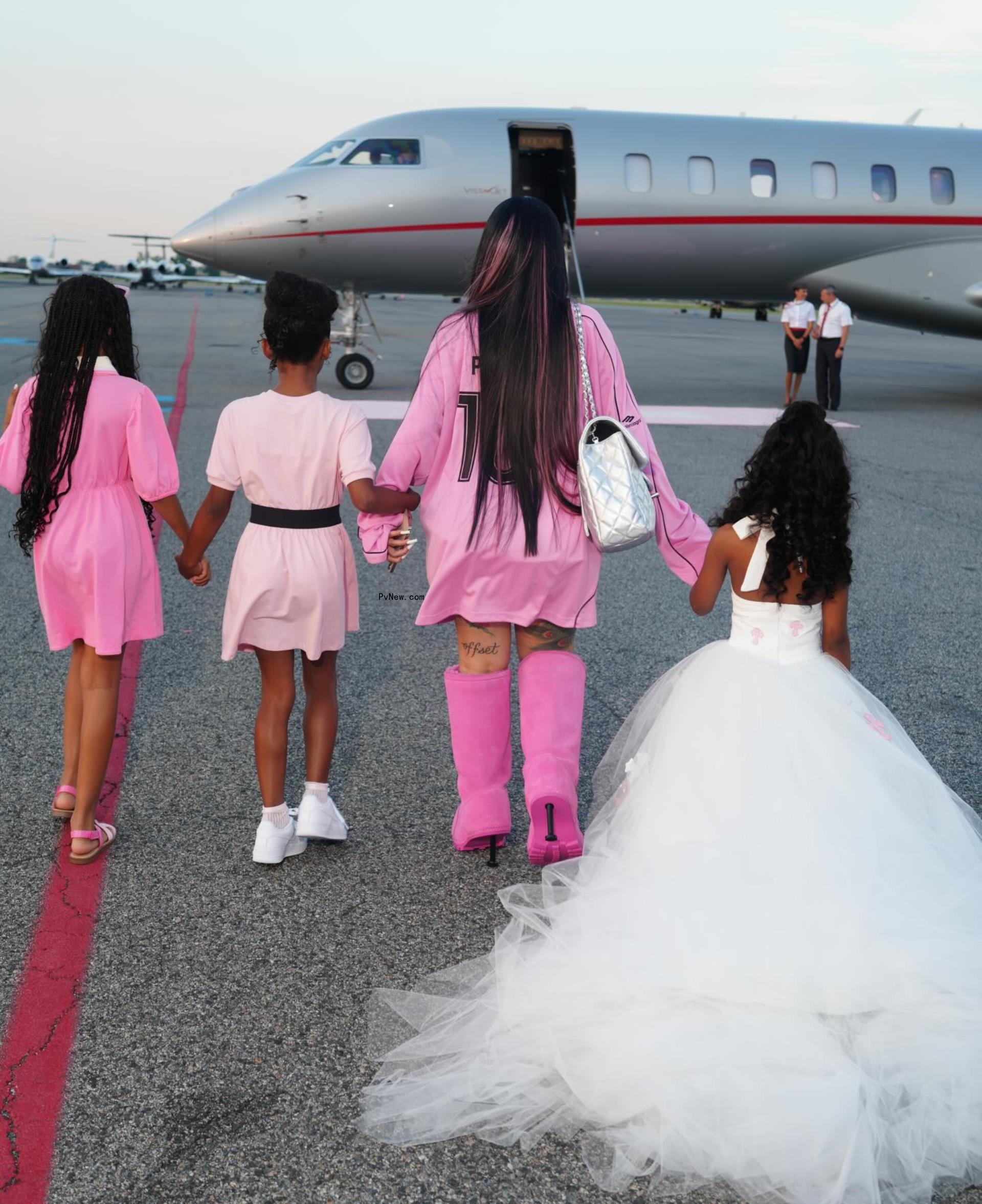 Cardi B and daughter walking toward jet in Instagram photo