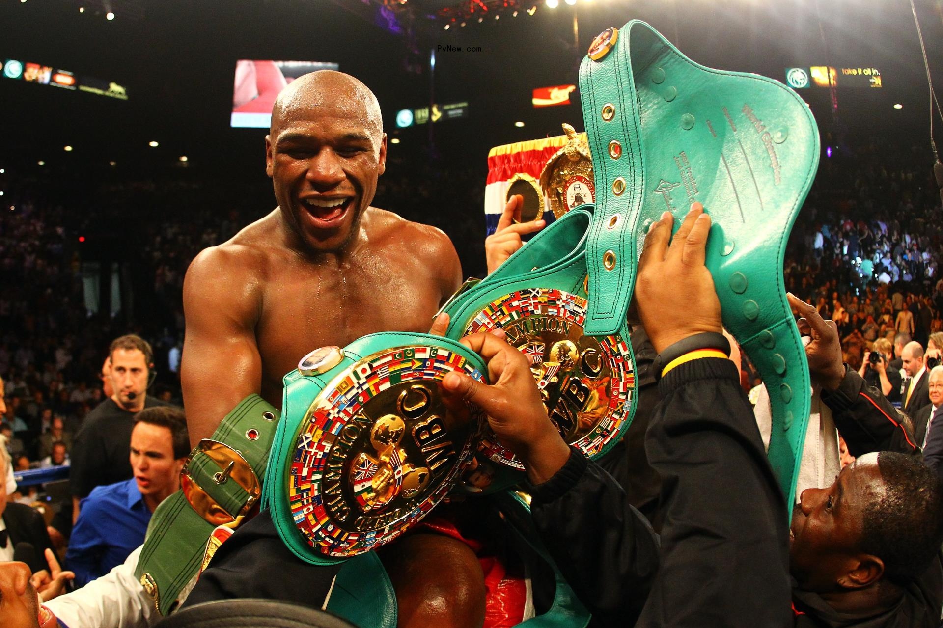 floyd mayweather celebrating his boxing win with a belt in 2012