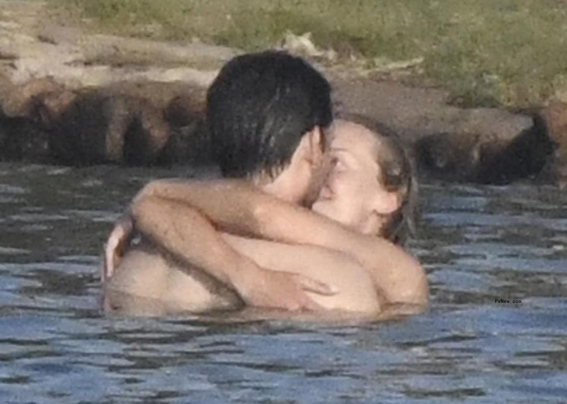 Tobey Maguire and Babette Strijbos kissing in the water.