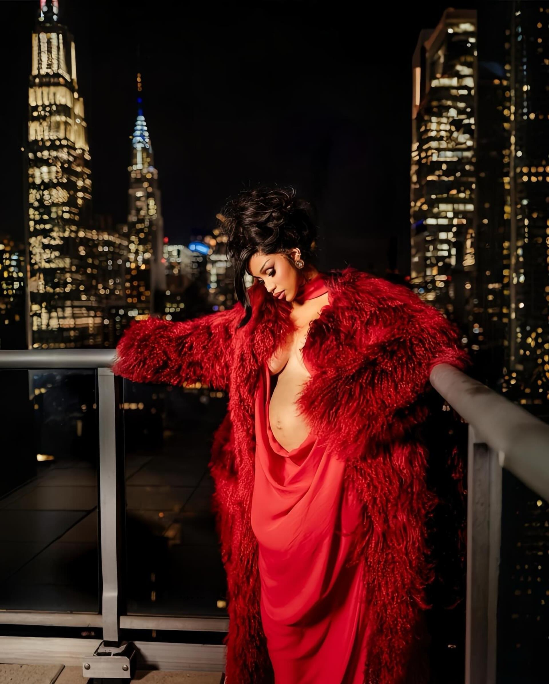 Cardi B posing with a baby bump