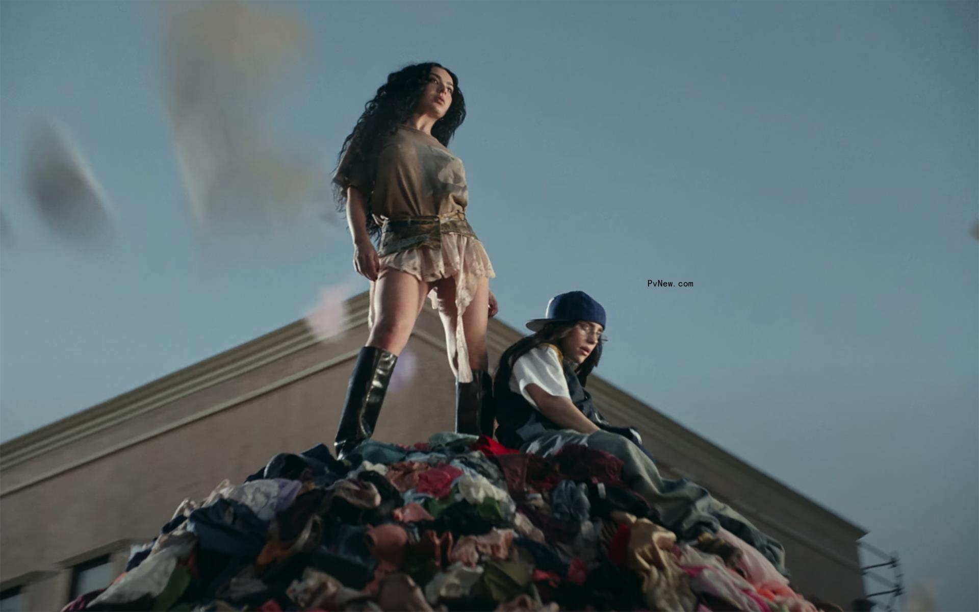 Charli XCX and Billie Eilish surrounded by underwear in the ‘Guess’ music video