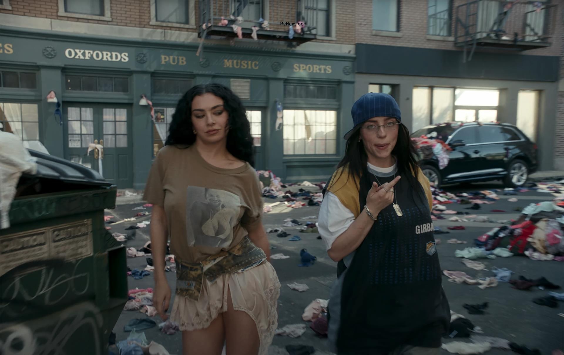 Charli XCX and Billie Eilish surrounded by underwear in the ‘Guess’ music video