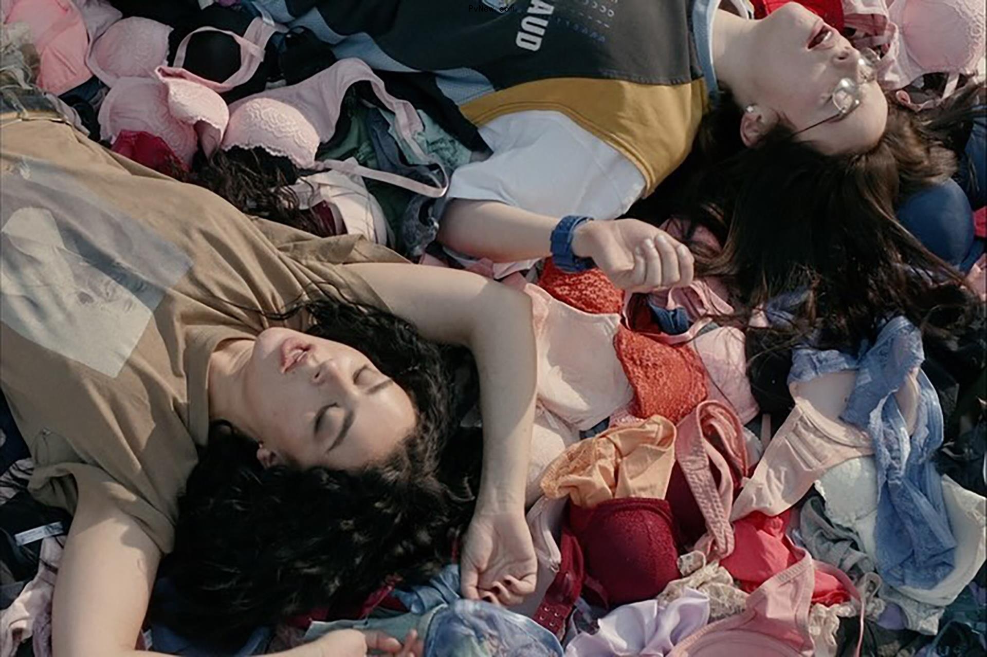 Charli XCX and Billie Eilish surrounded by underwear in the ‘Guess’ music video