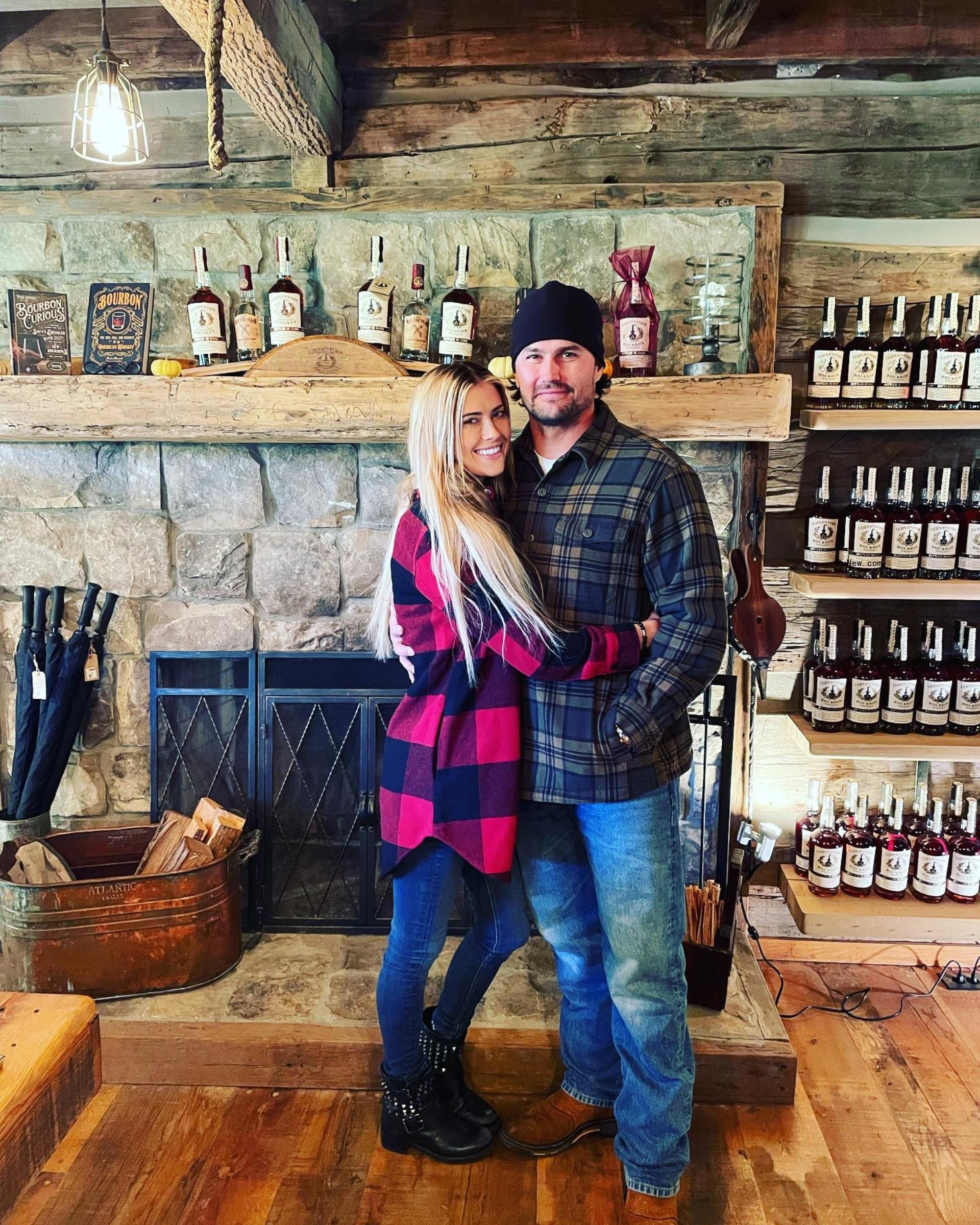 christina and josh hall posing with their arms wrapped around each other