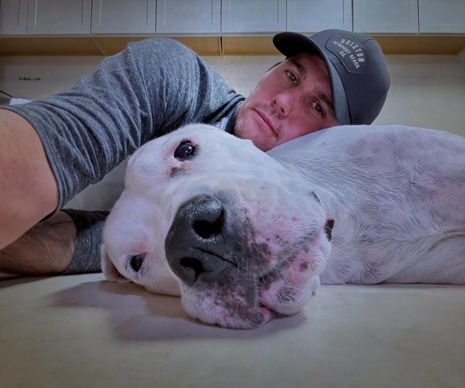 josh hall resting his head on his dog