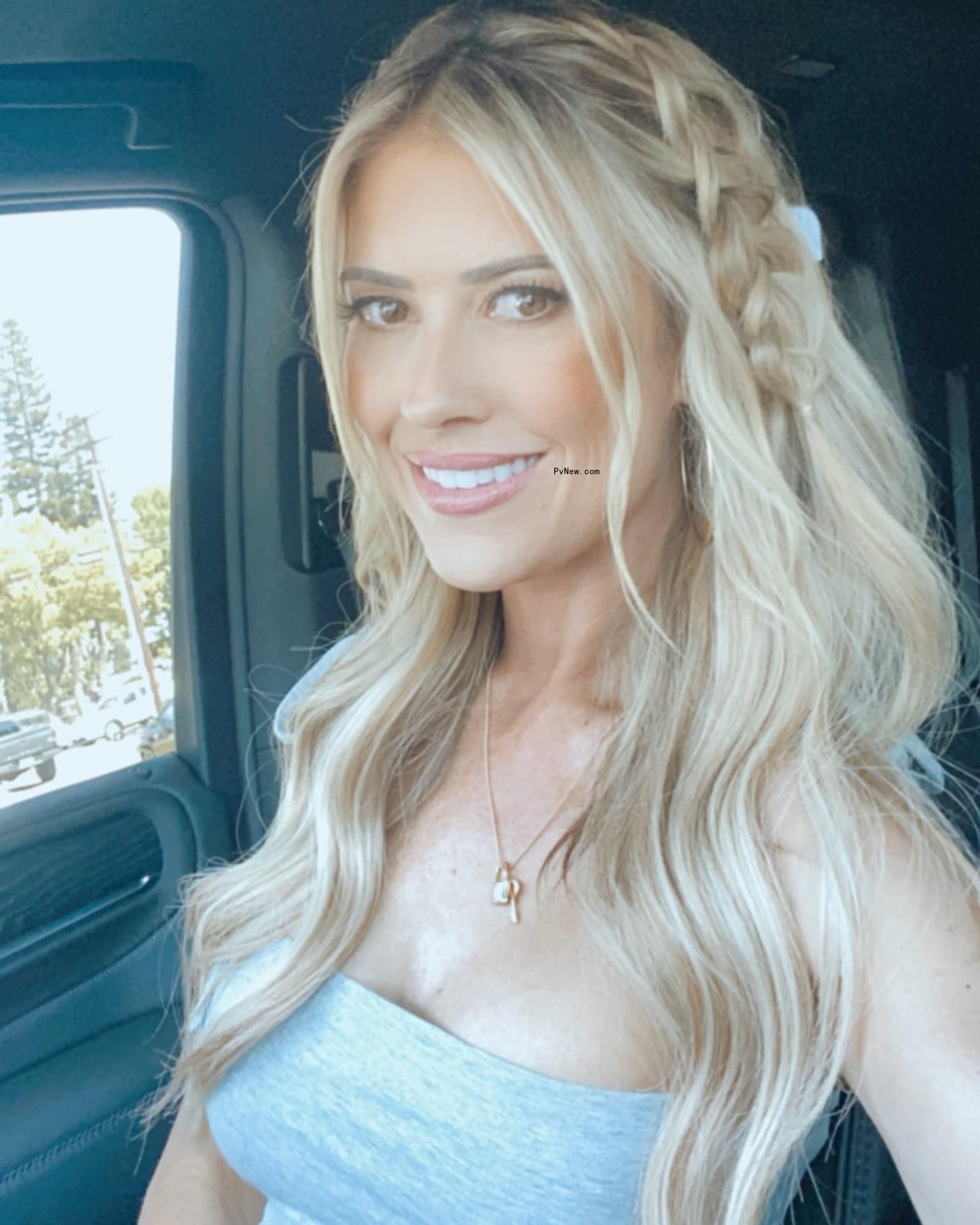 Christina hall poses while in the car.