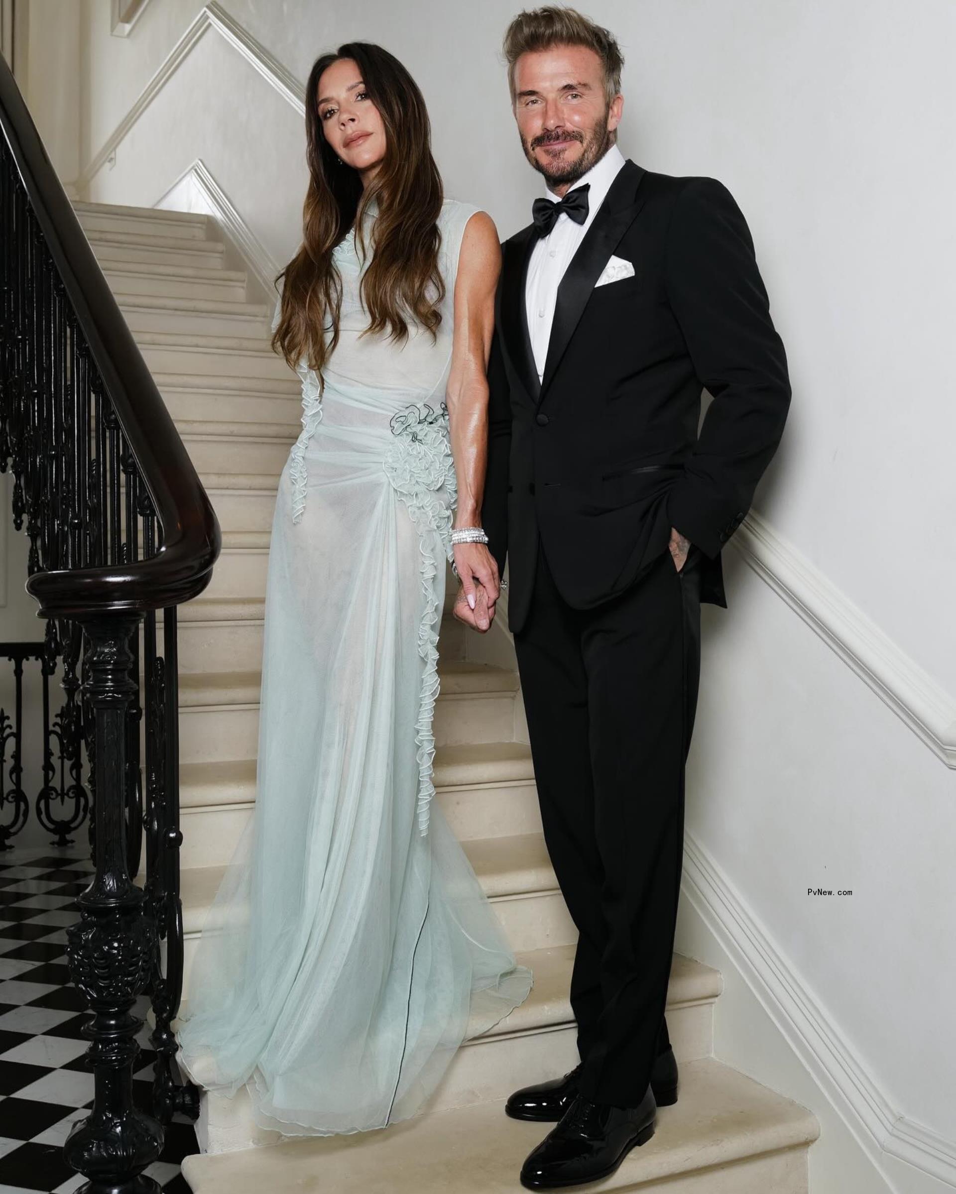 Victoria Beckham and David Beckham pose at her 50th birthday party together.