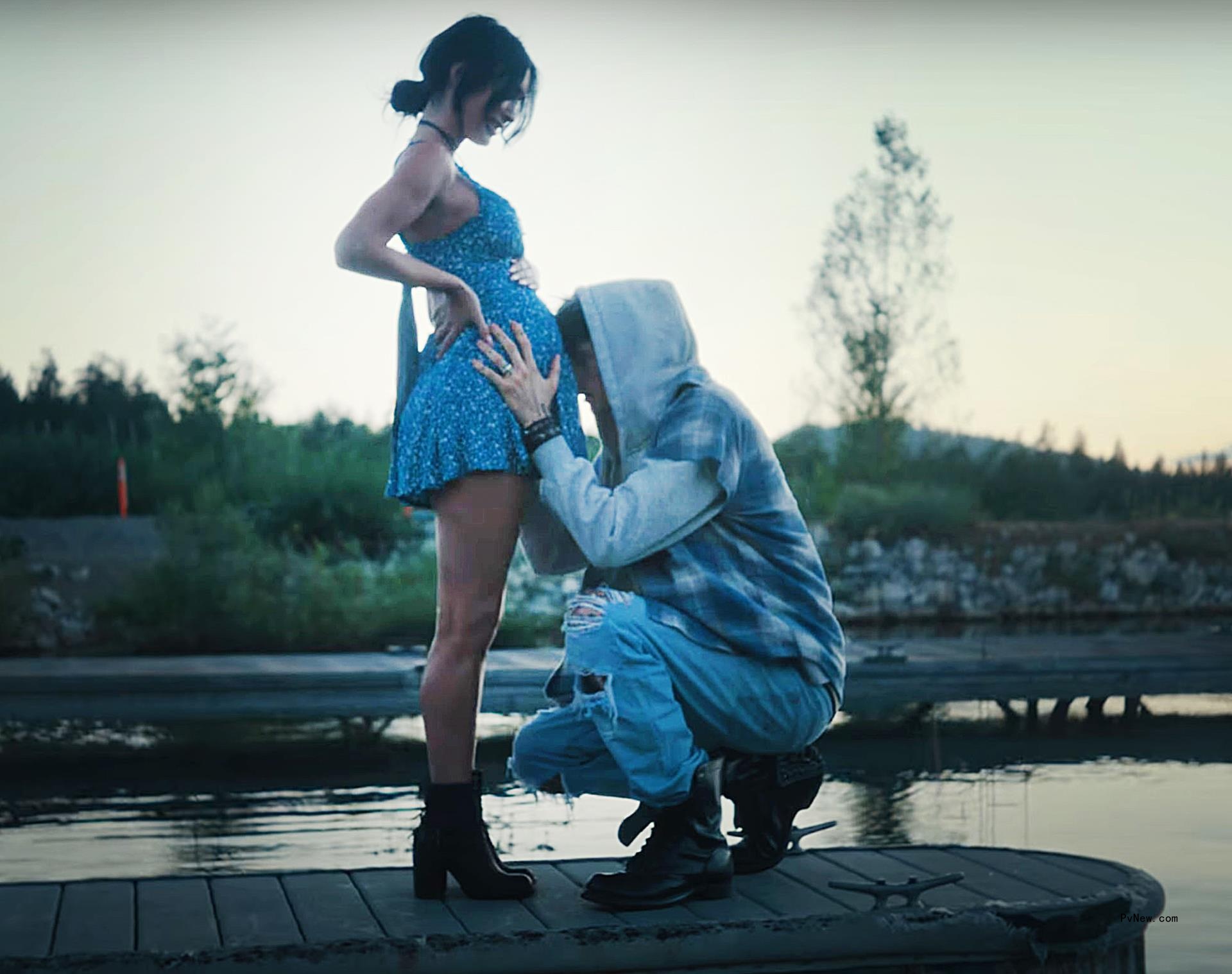Machine Gun Kelly touches Megan Fox's baby bump in July 26