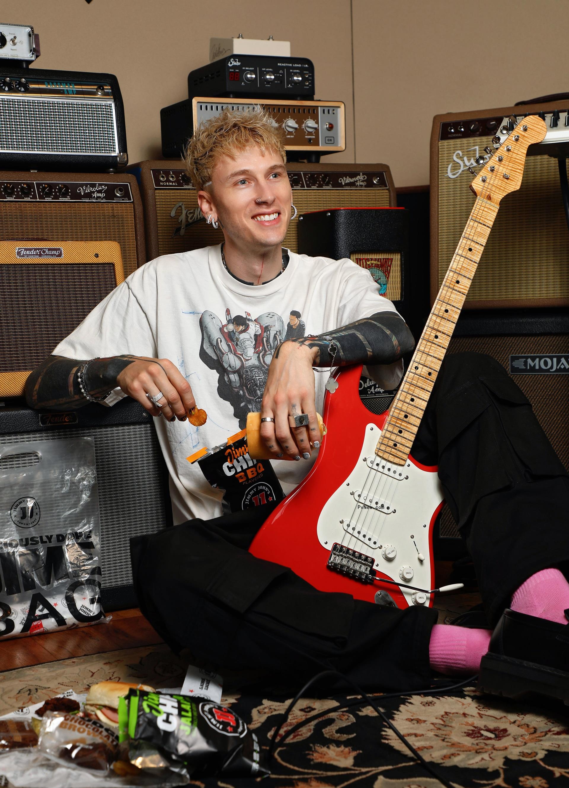 Machine Gun Kelly poses with guitar