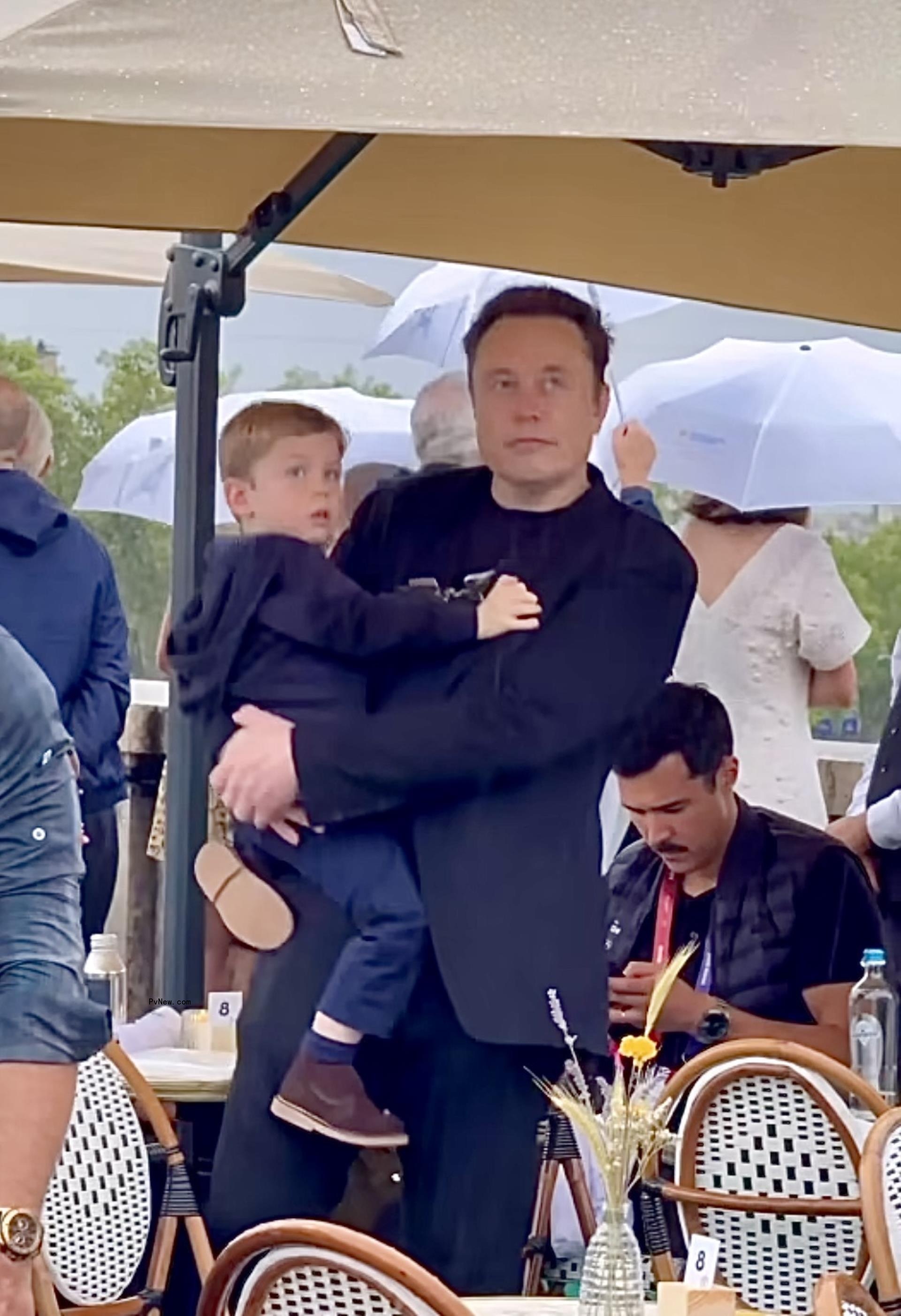 Elon Musk holding his son.