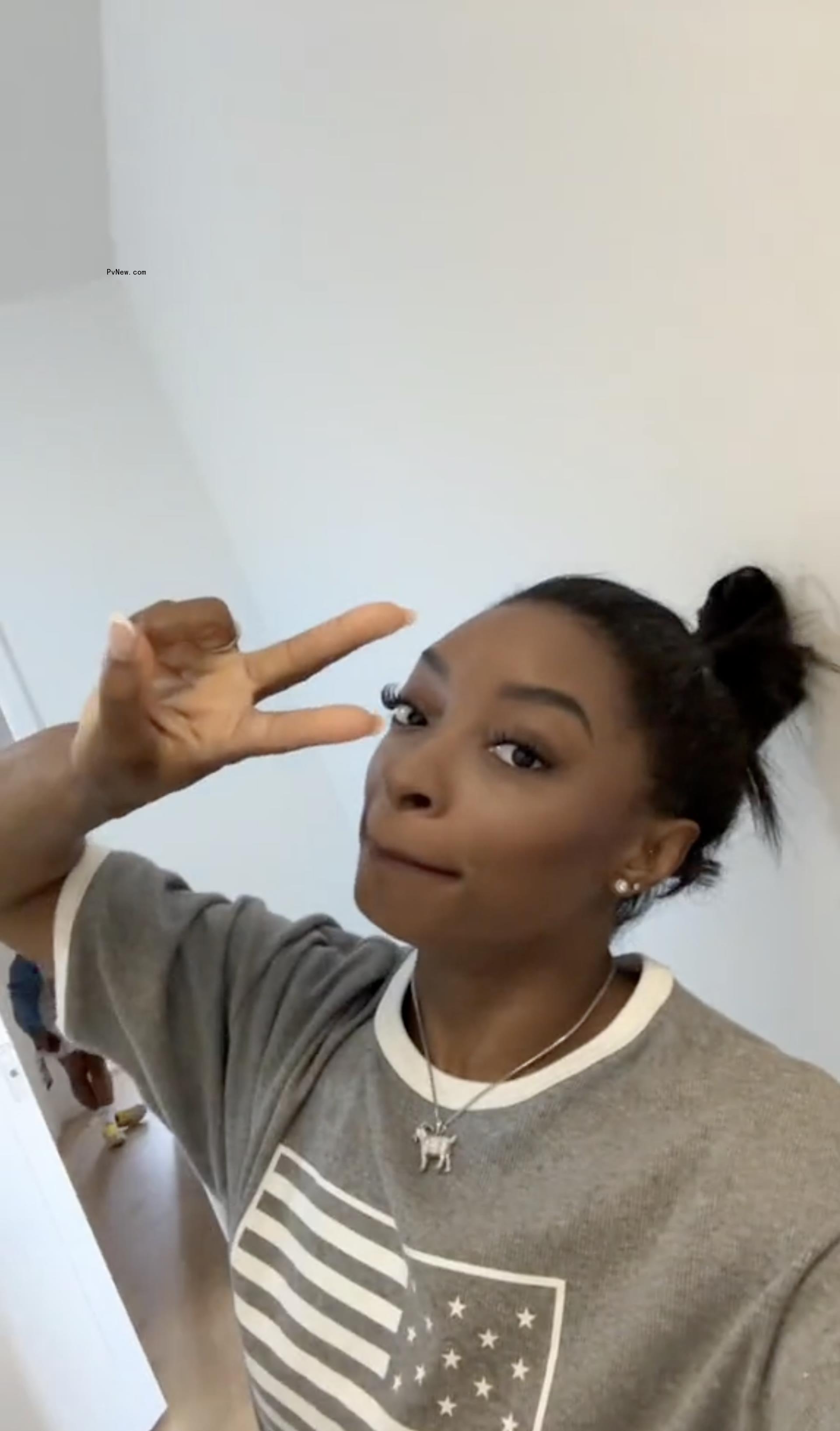 Simone Biles making a peace sign.