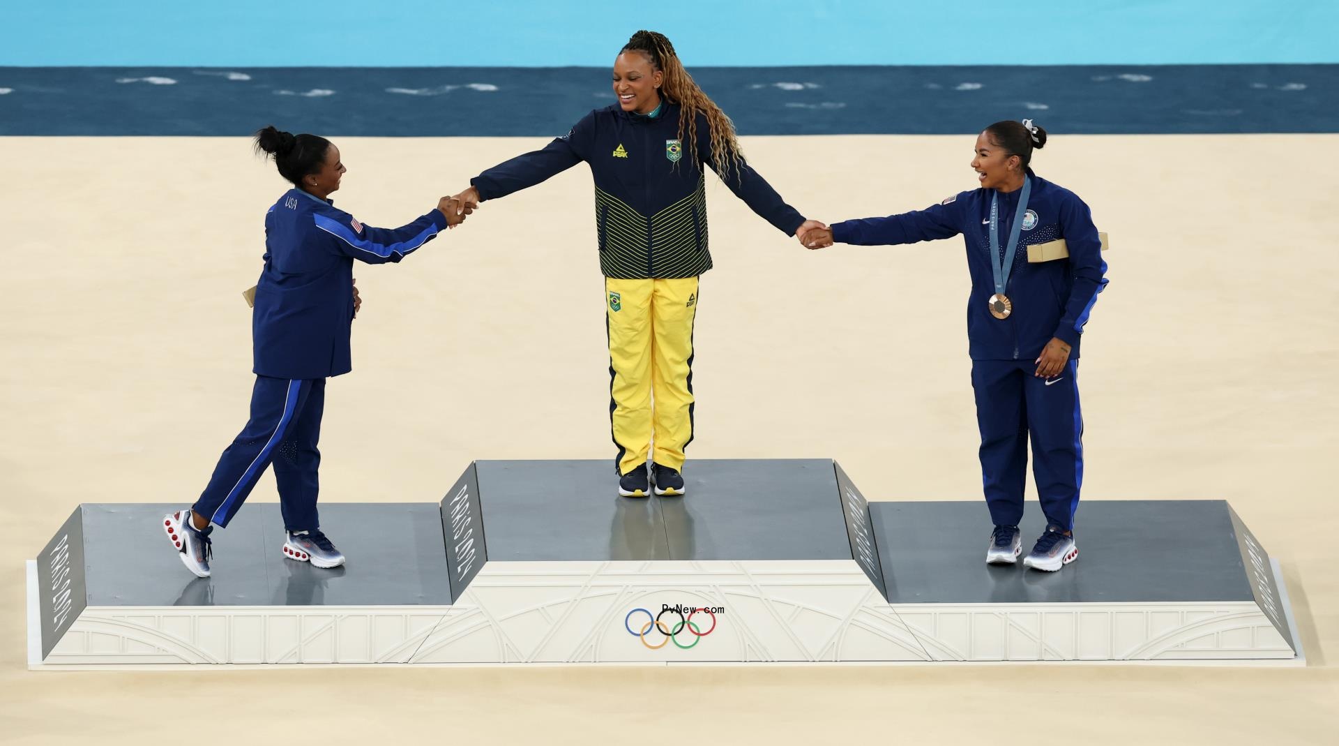 Simone Biles, Rebeca Andrade and Suni Lee on the podium.