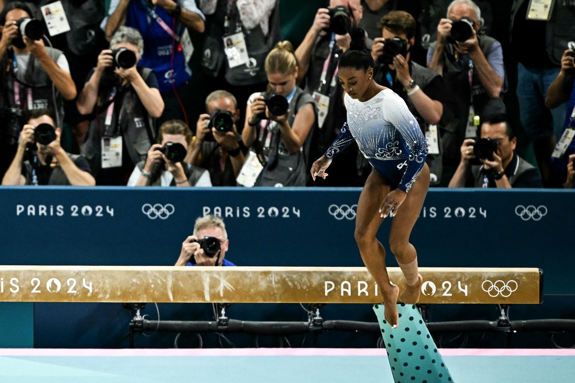 Simone Biles competing in the balance beam finals in the 2024 Olympics.
