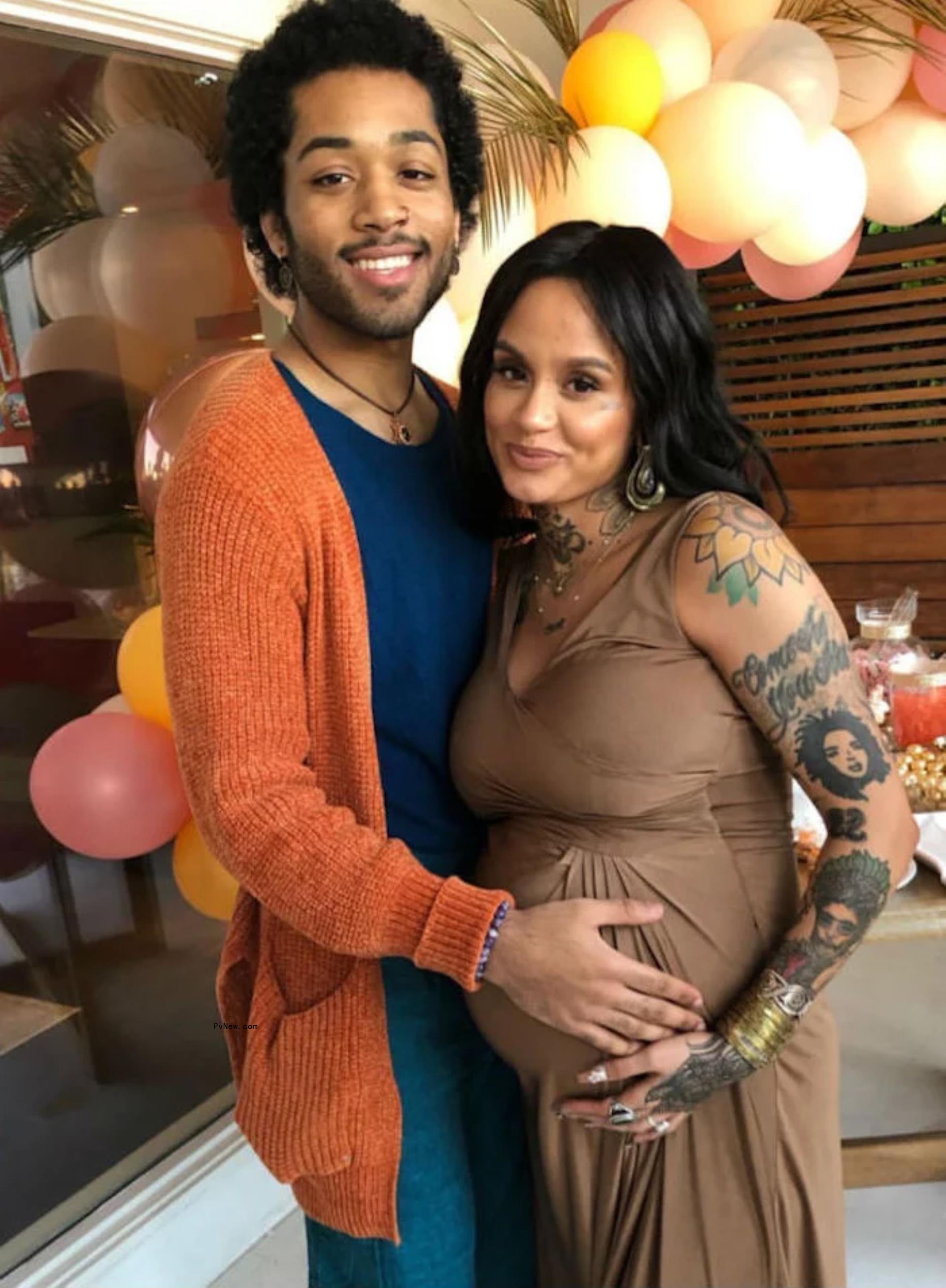 Javaughn Young-White touching Kehlani's baby bump.