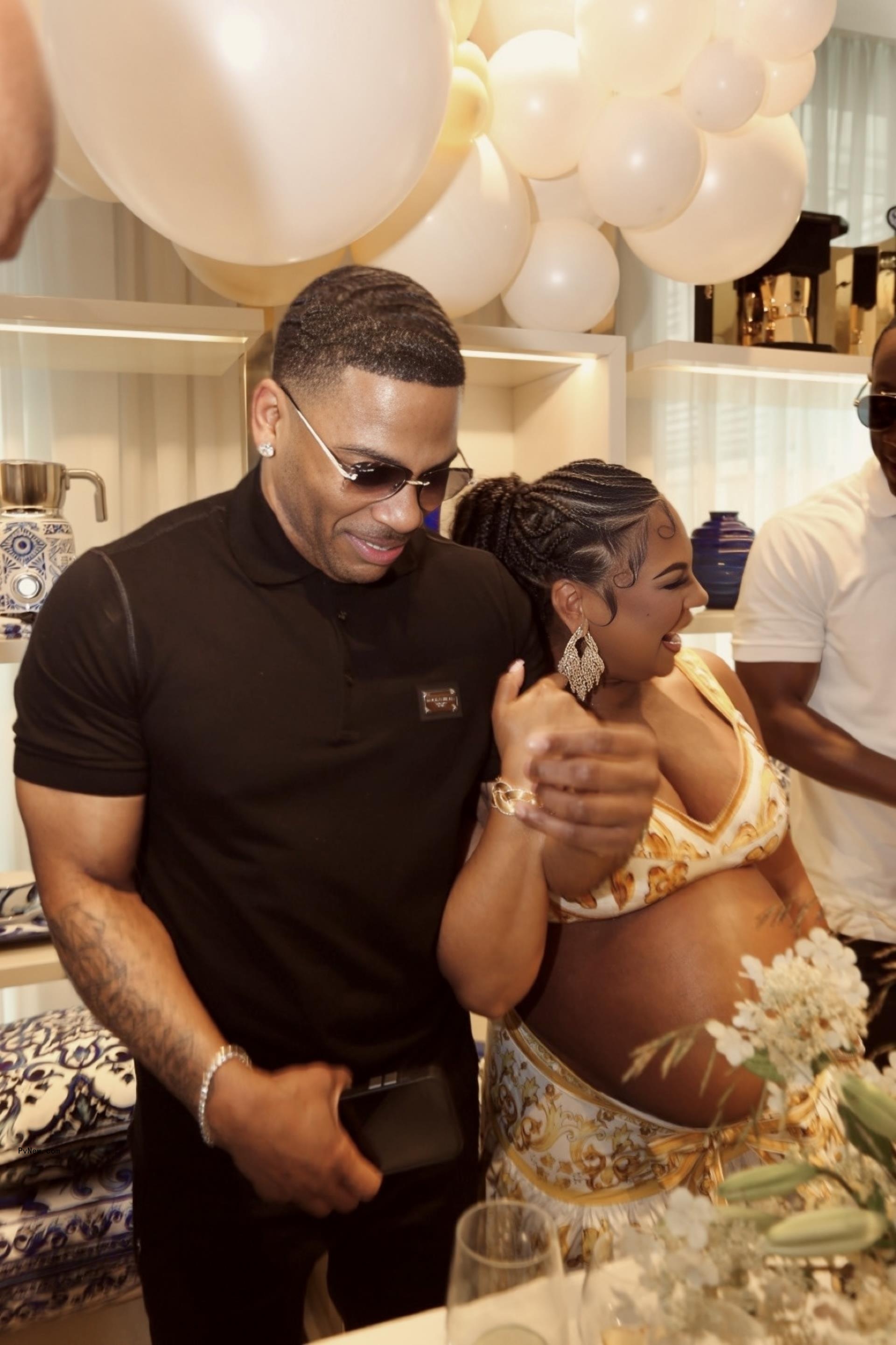 Nelly and a pregnant Ashanti.