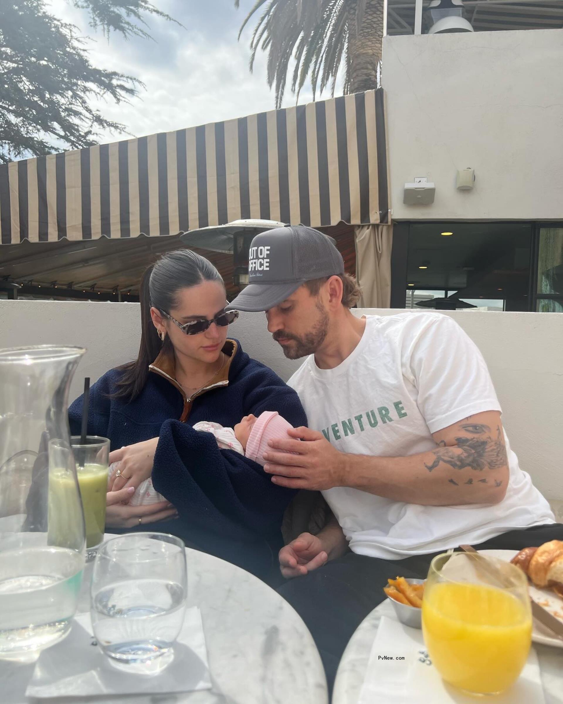 Nick Viall and Natalie Joy sitting with their baby