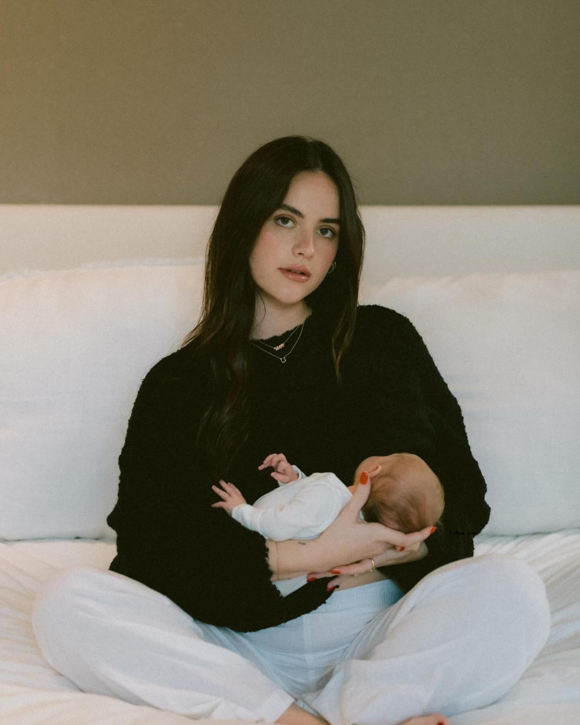 Natalie Joy posing with her baby