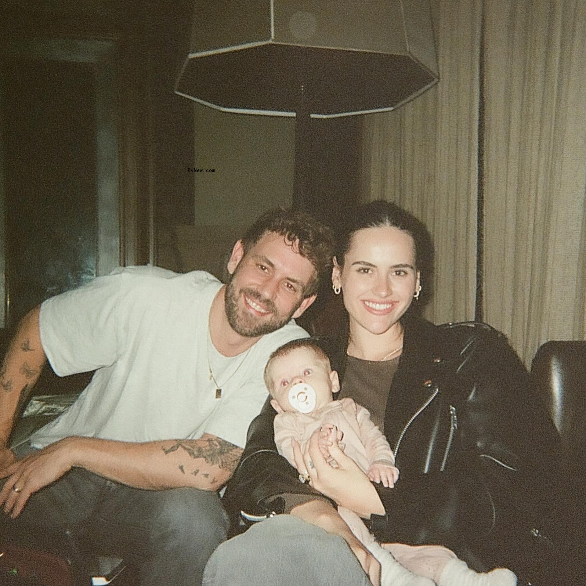 Nick Viall and Natalie Joy posing with their daughter