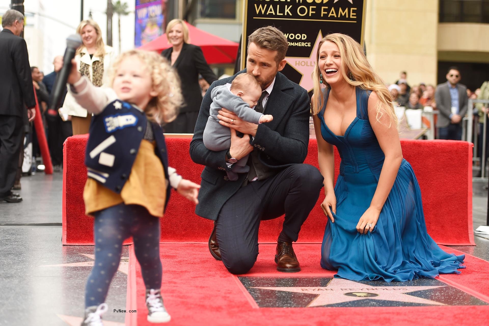 Blake Lively and Ryan Reynolds posing with their daughters